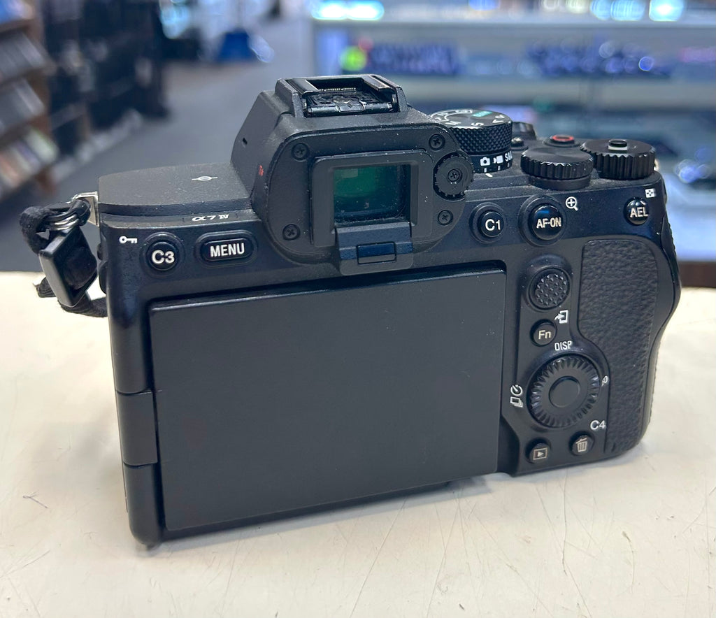 Sony A7 IV Camera body on a light surface with a blurred background