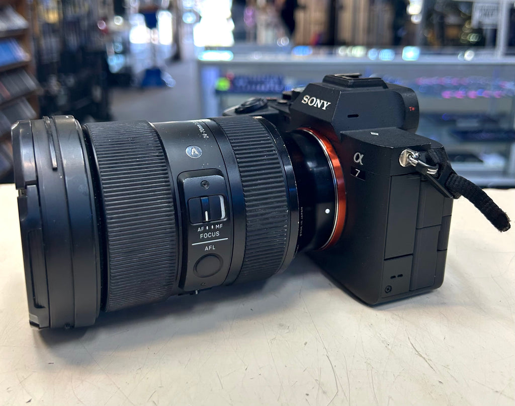 Sony camera with lens on a light surface, blurred store background
