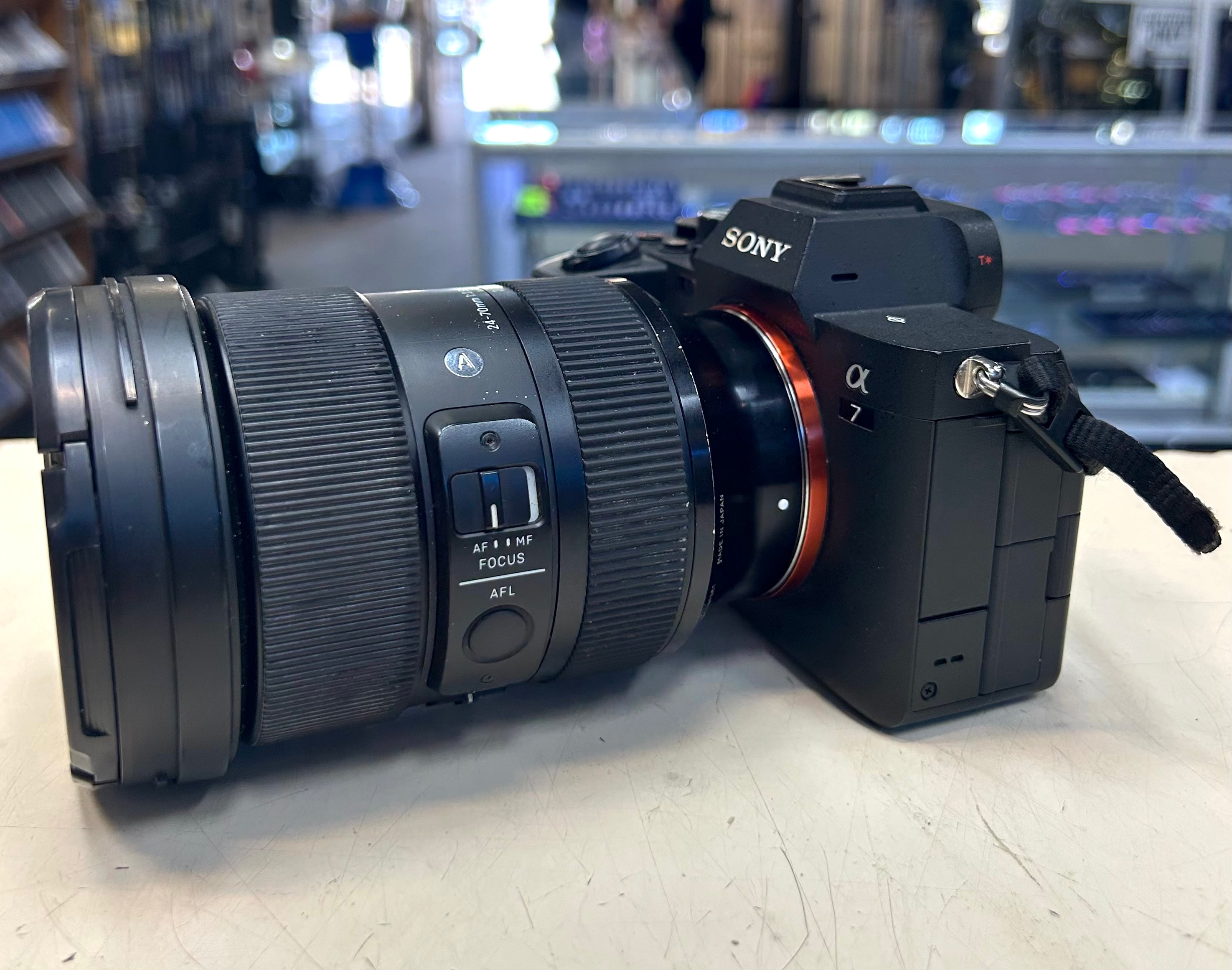 Sony camera with lens on a light surface, blurred store background