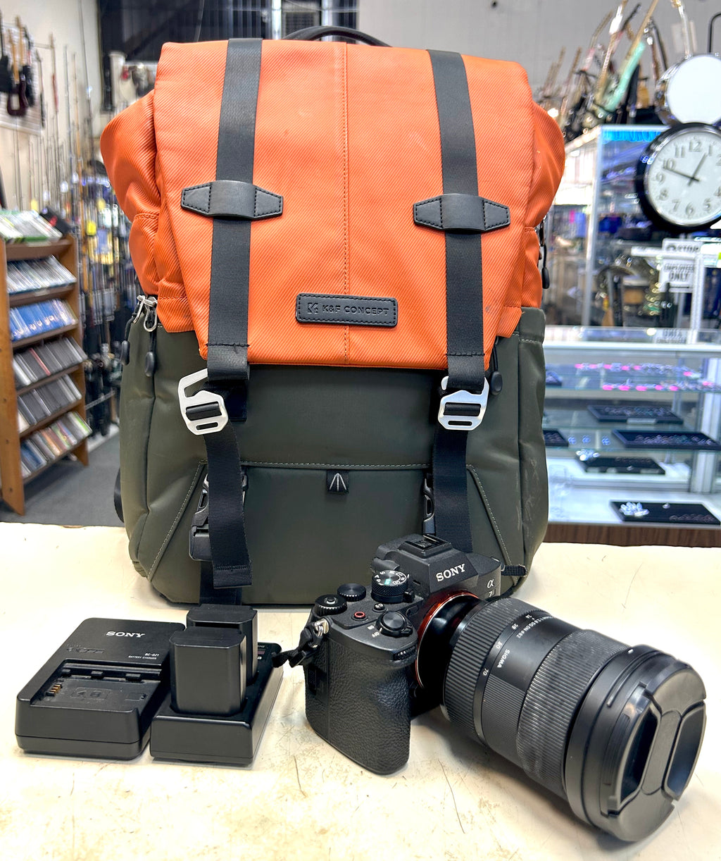 Sony A7 4 Camera backpack with camera equipment on a counter in a store setting