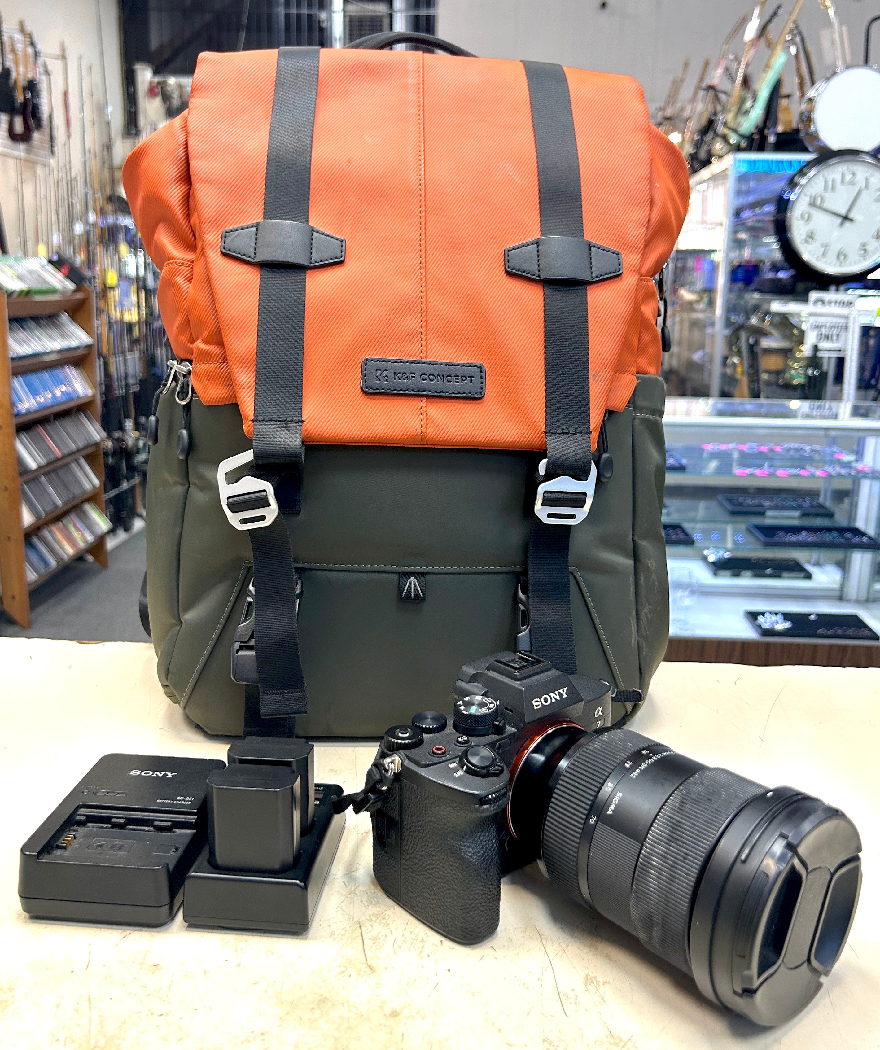 Sony A7 4 Camera backpack with camera equipment on a counter in a store setting