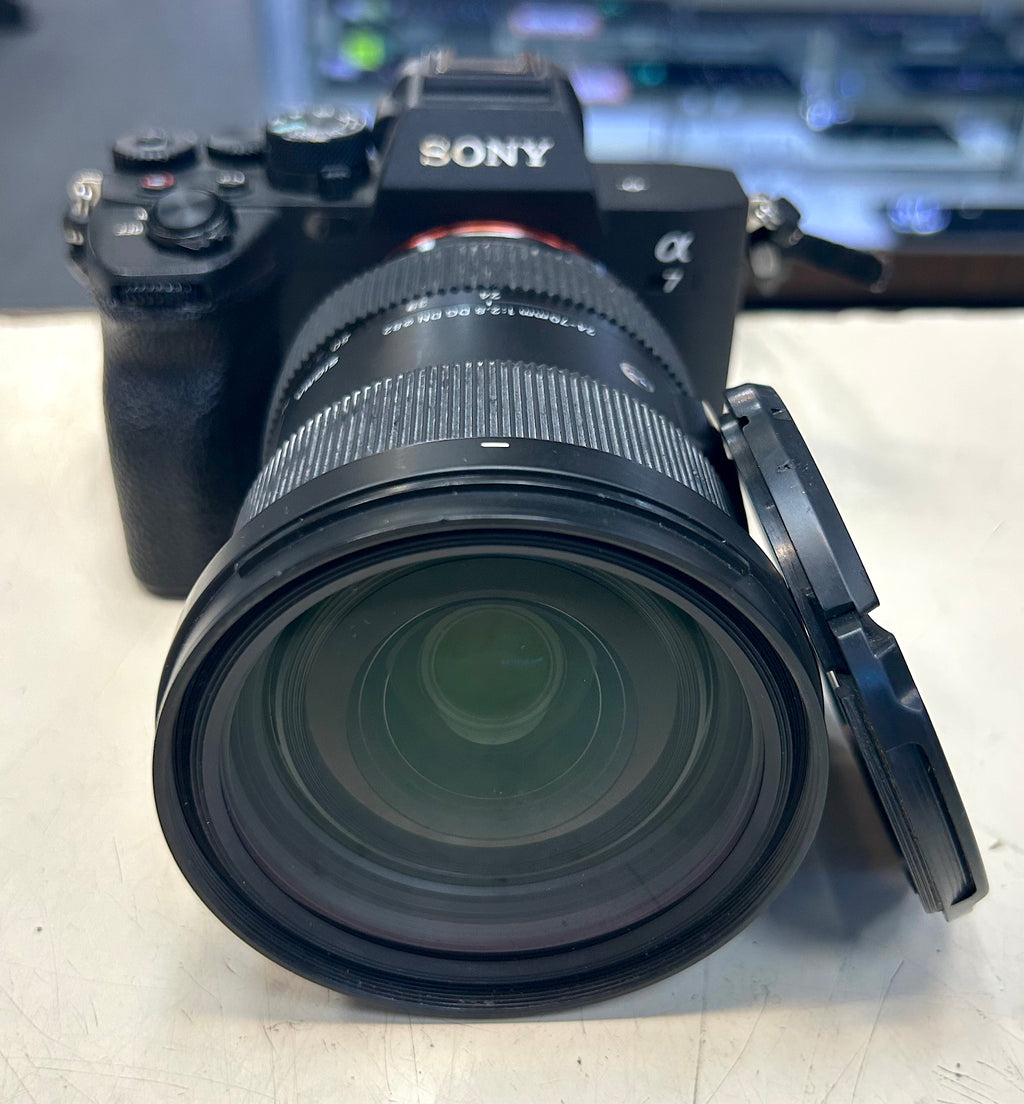 Sony A7 with sigma lens camera with lens on a light surface