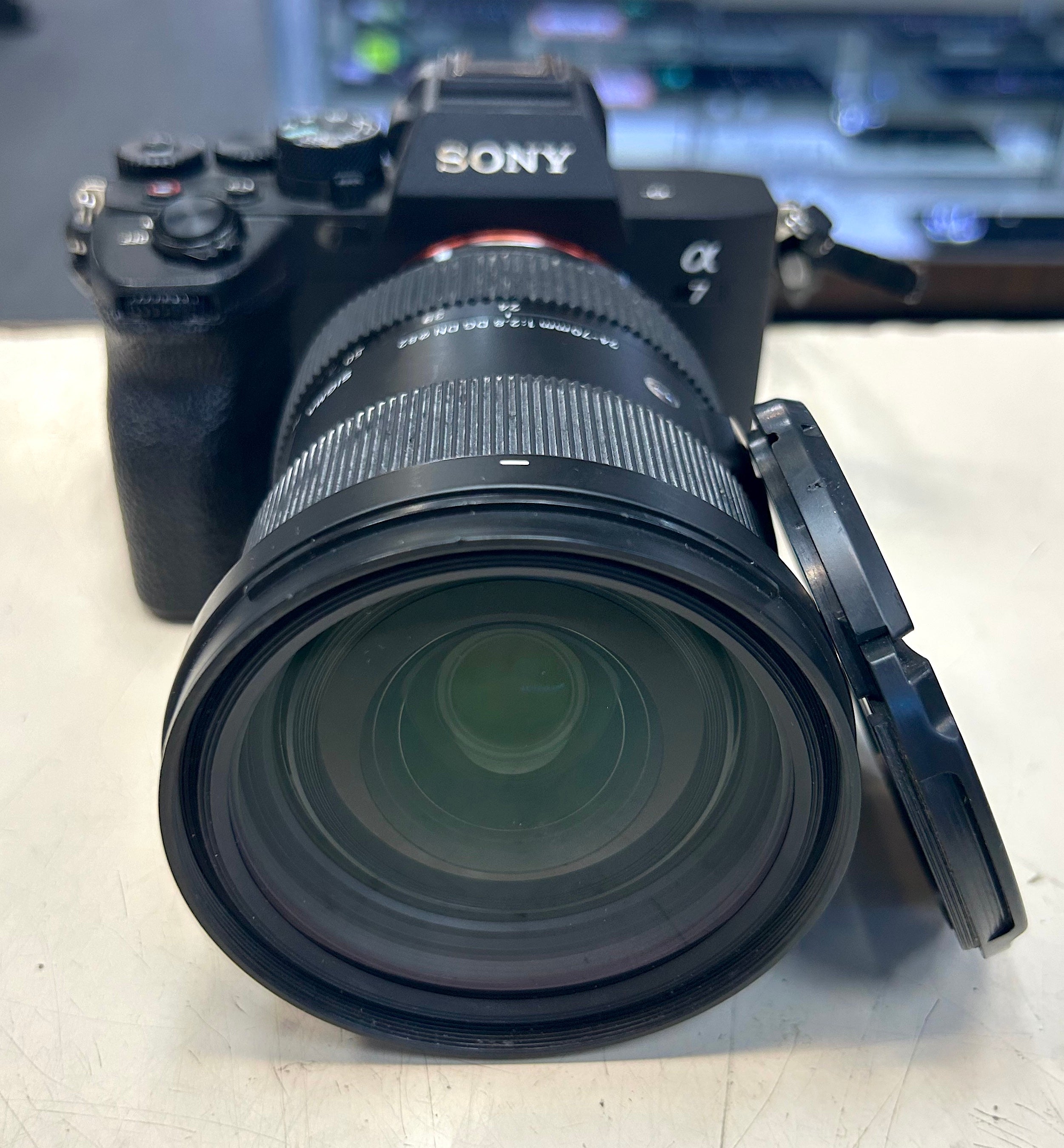 Sony A7 with sigma lens camera with lens on a light surface