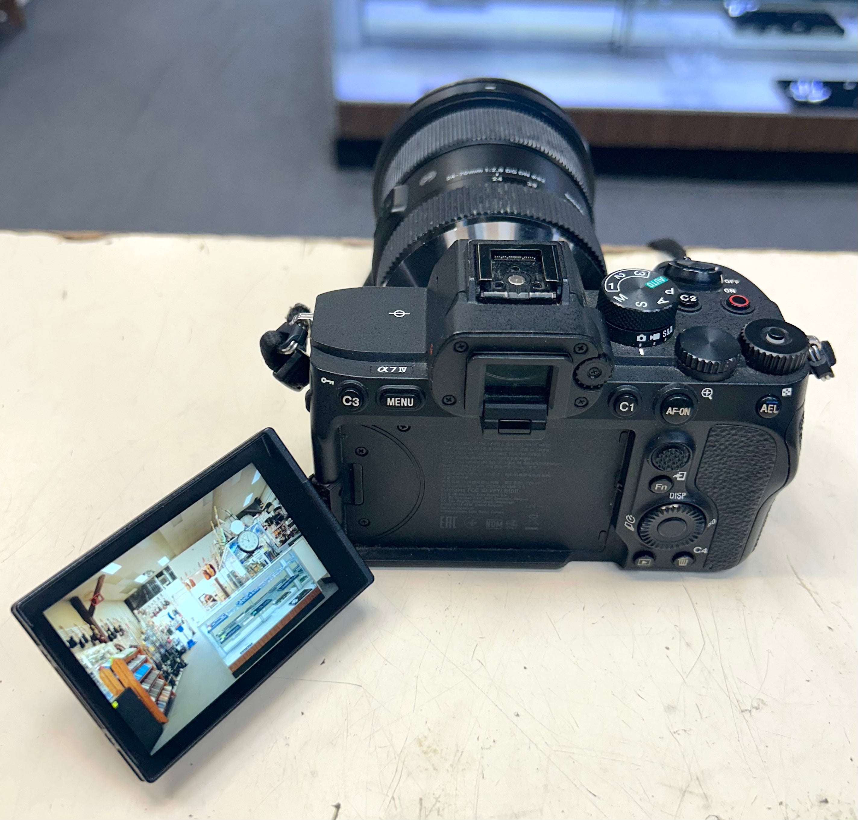 Sony A7 4 Camera with a screen displaying an image on a light surface
