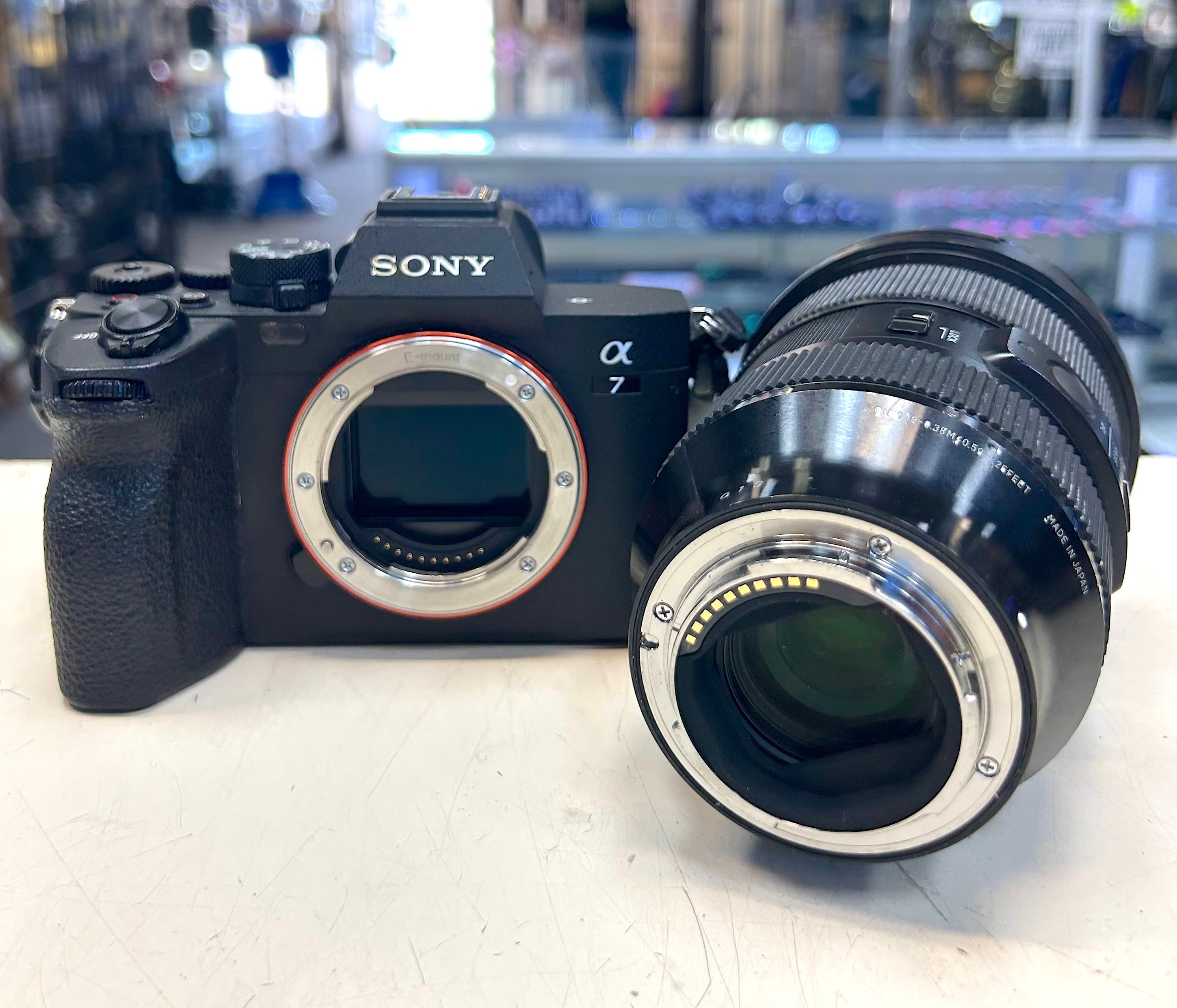Sony A7 IV camera with Sigma lens on a white surface