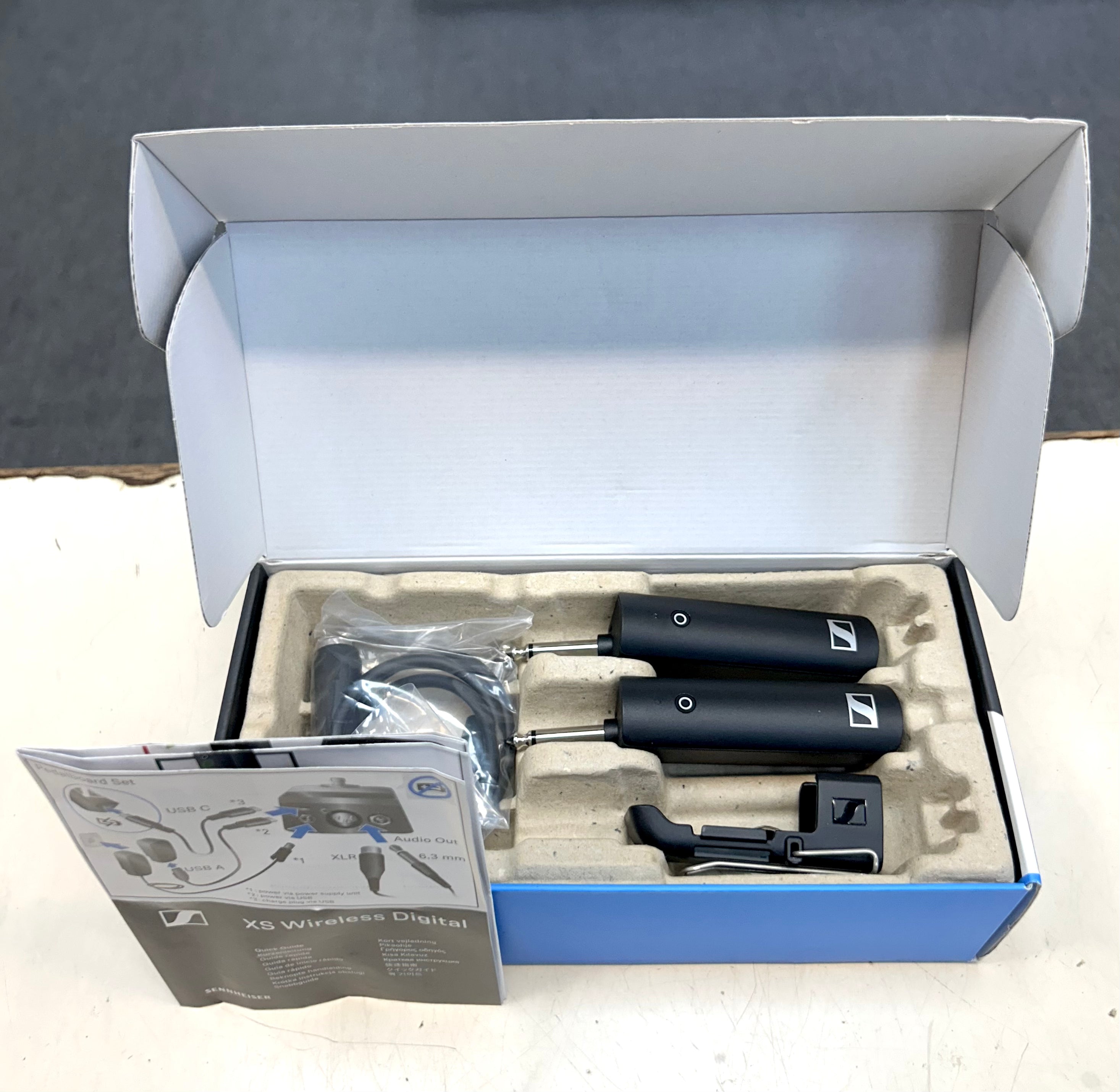 Sennheiser wireless microphone system in open box on a gray background