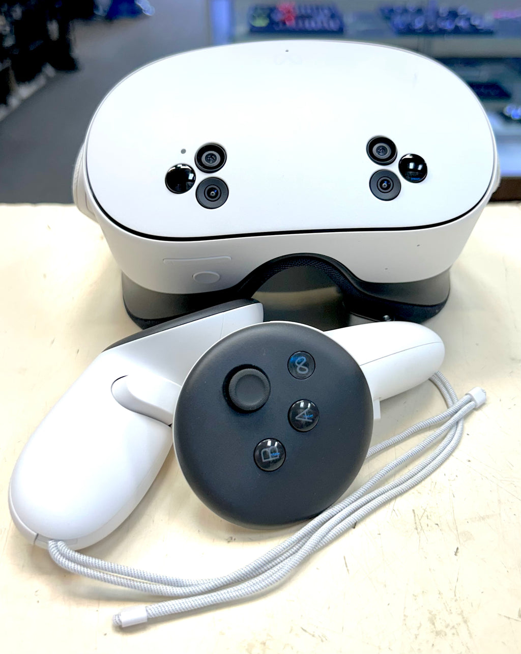 Meta Quest 3 White VR headset and controllers on a light surface with a blurred background