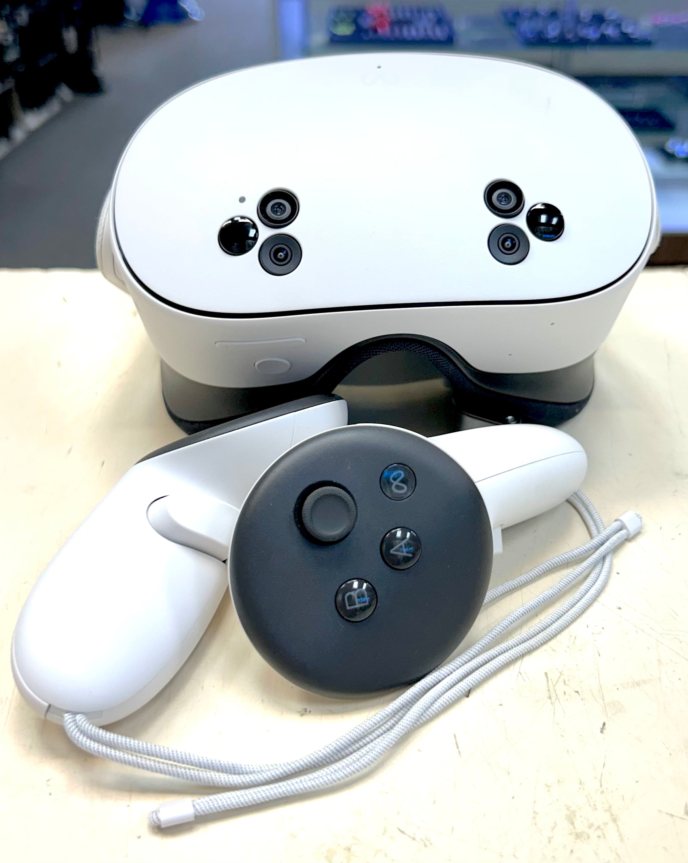 Meta Quest 3 White VR headset and controllers on a light surface with a blurred background