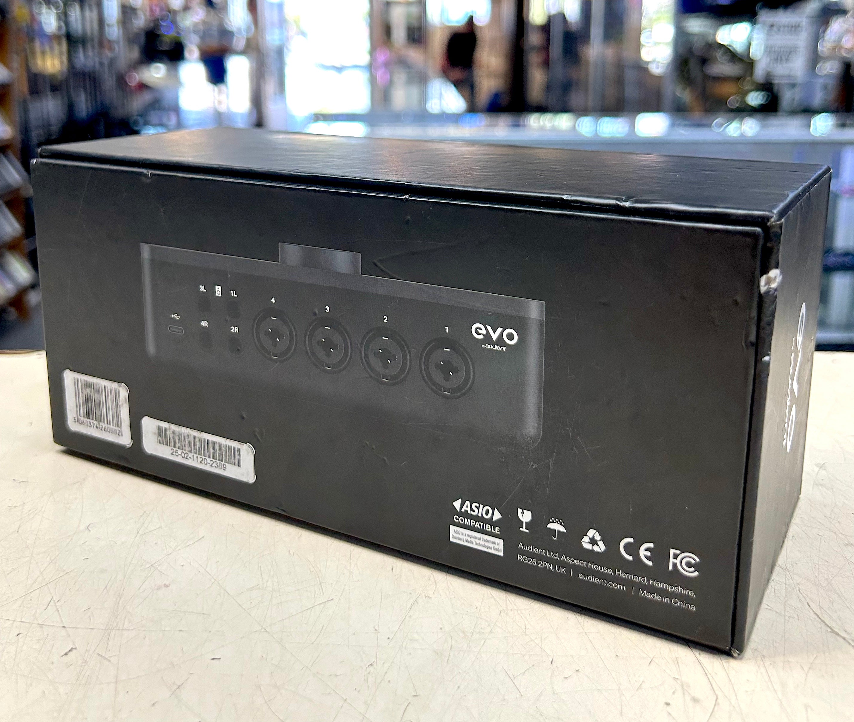 Black electronic device packaging with 'evo' branding on a light surface.