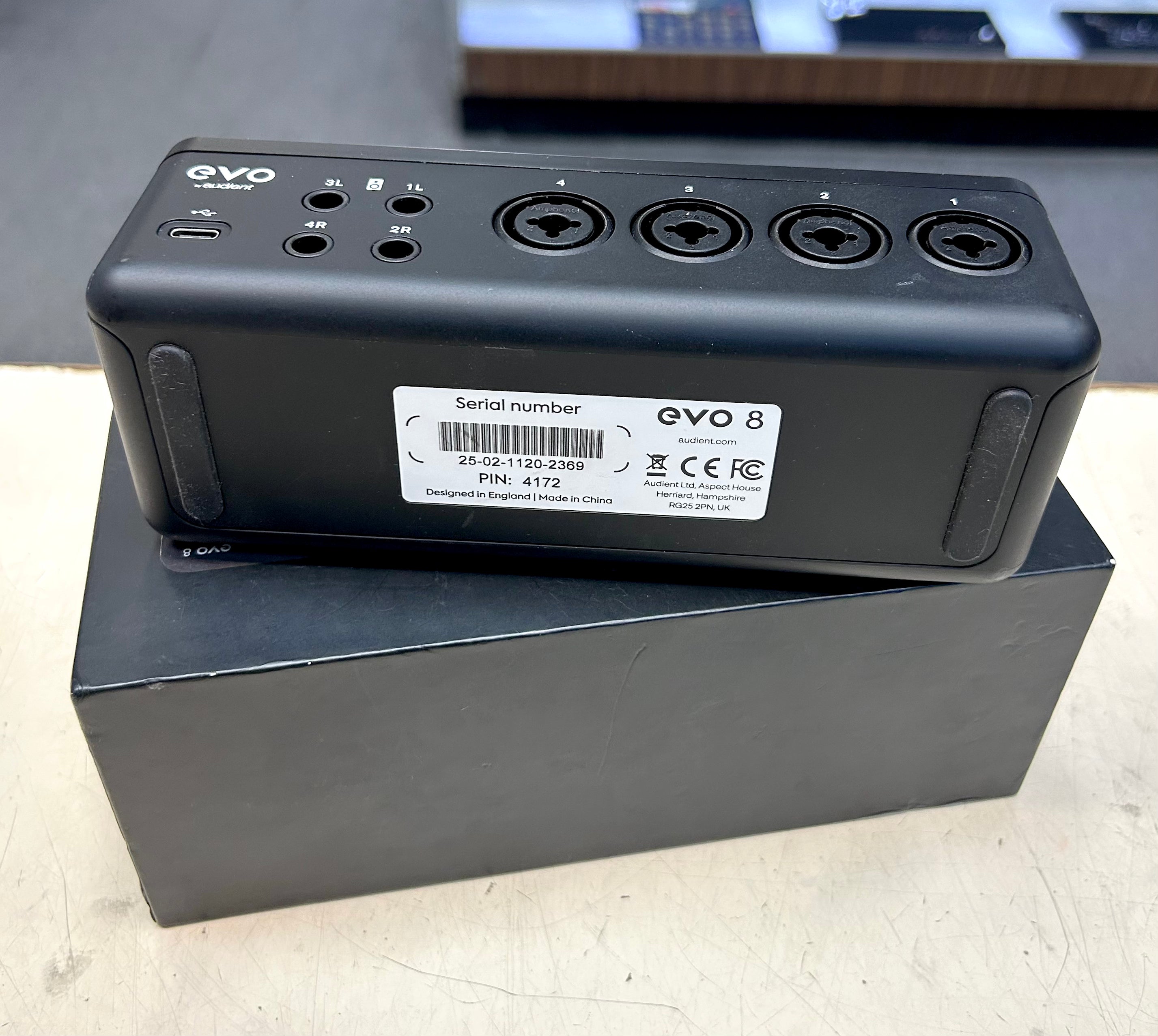 Black electronic device with 'EVO' branding on a cardboard box