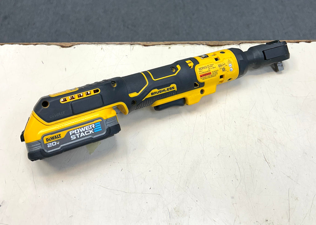 DeWalt power tool on a white surface with a gray background