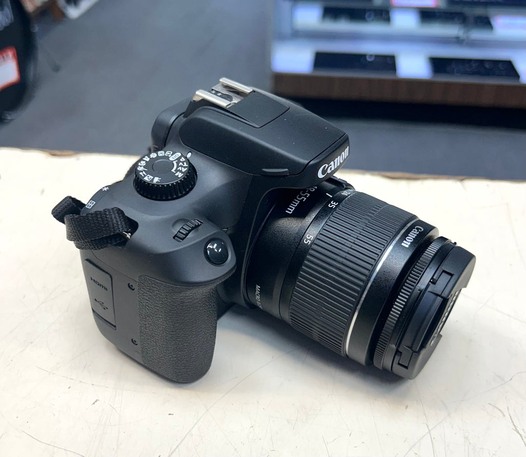 Canon DSLR camera on a light surface with a blurred background