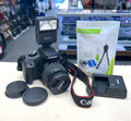 Canon camera with accessories on a table in a store setting