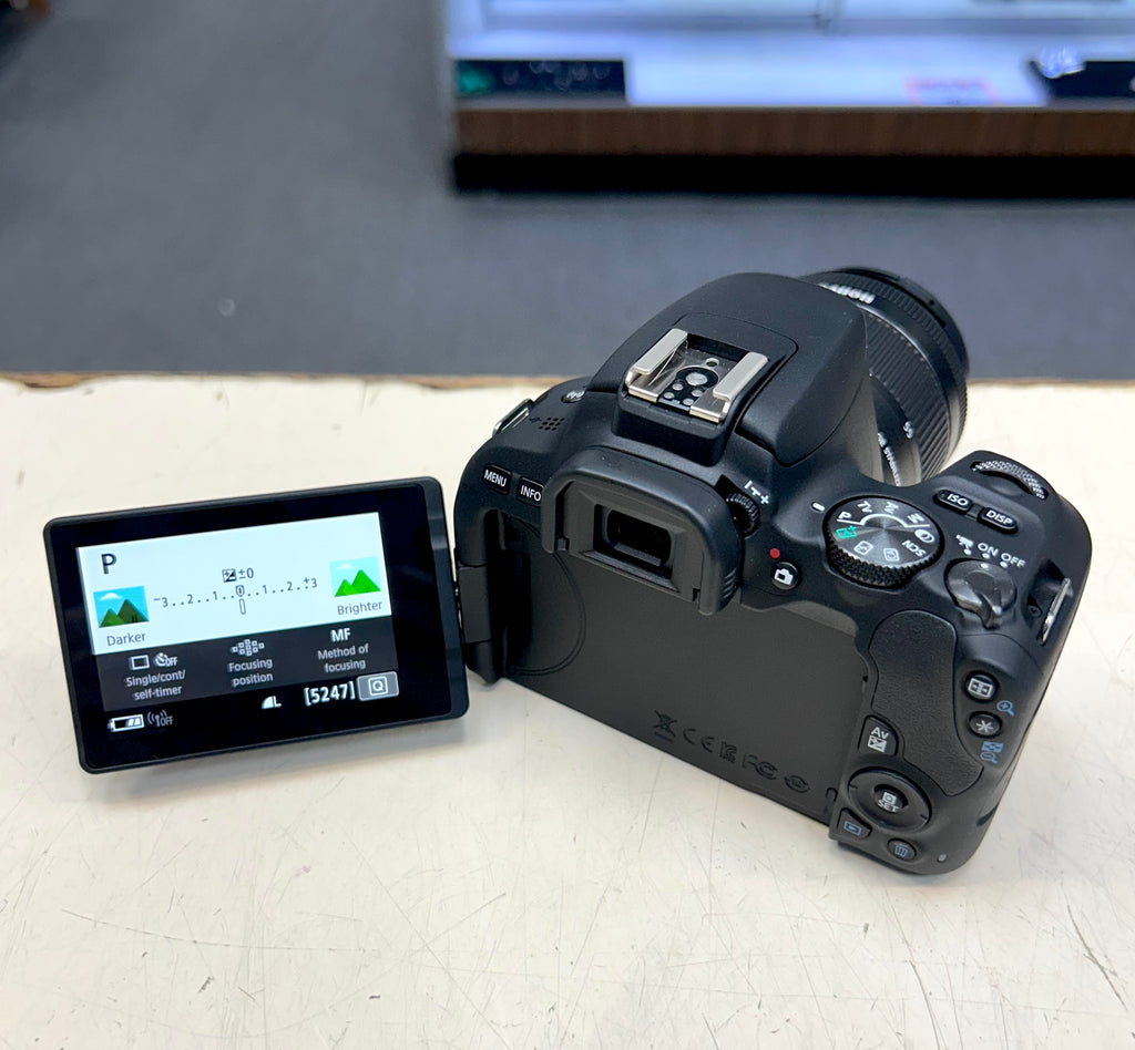 Black camera with a screen on a light surface
