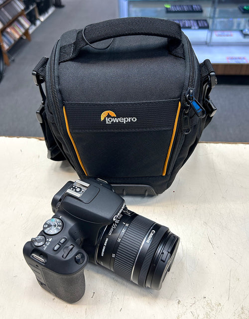 Camera and LowePro camera bag on a light surface with a blurred background