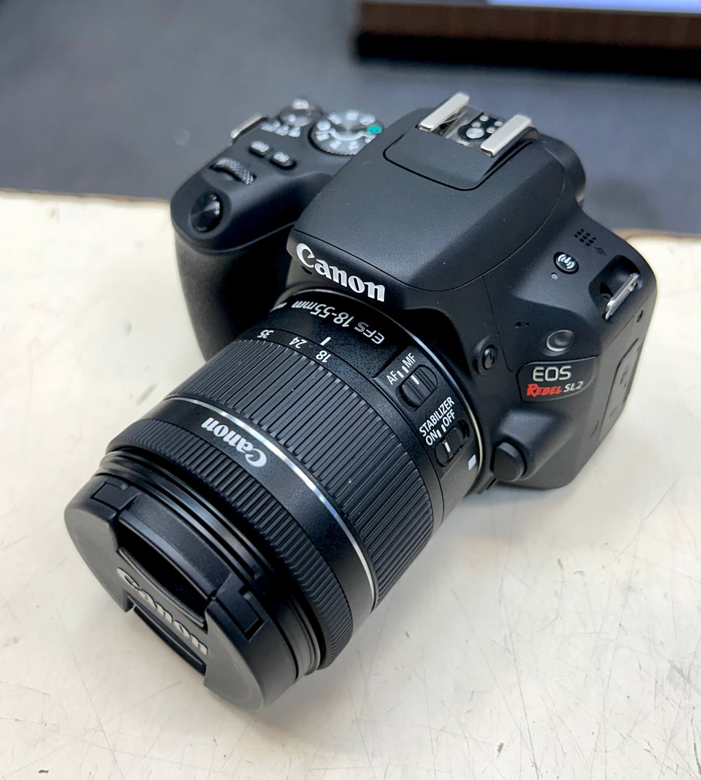 Canon DSLR camera on a light surface with a blurred background