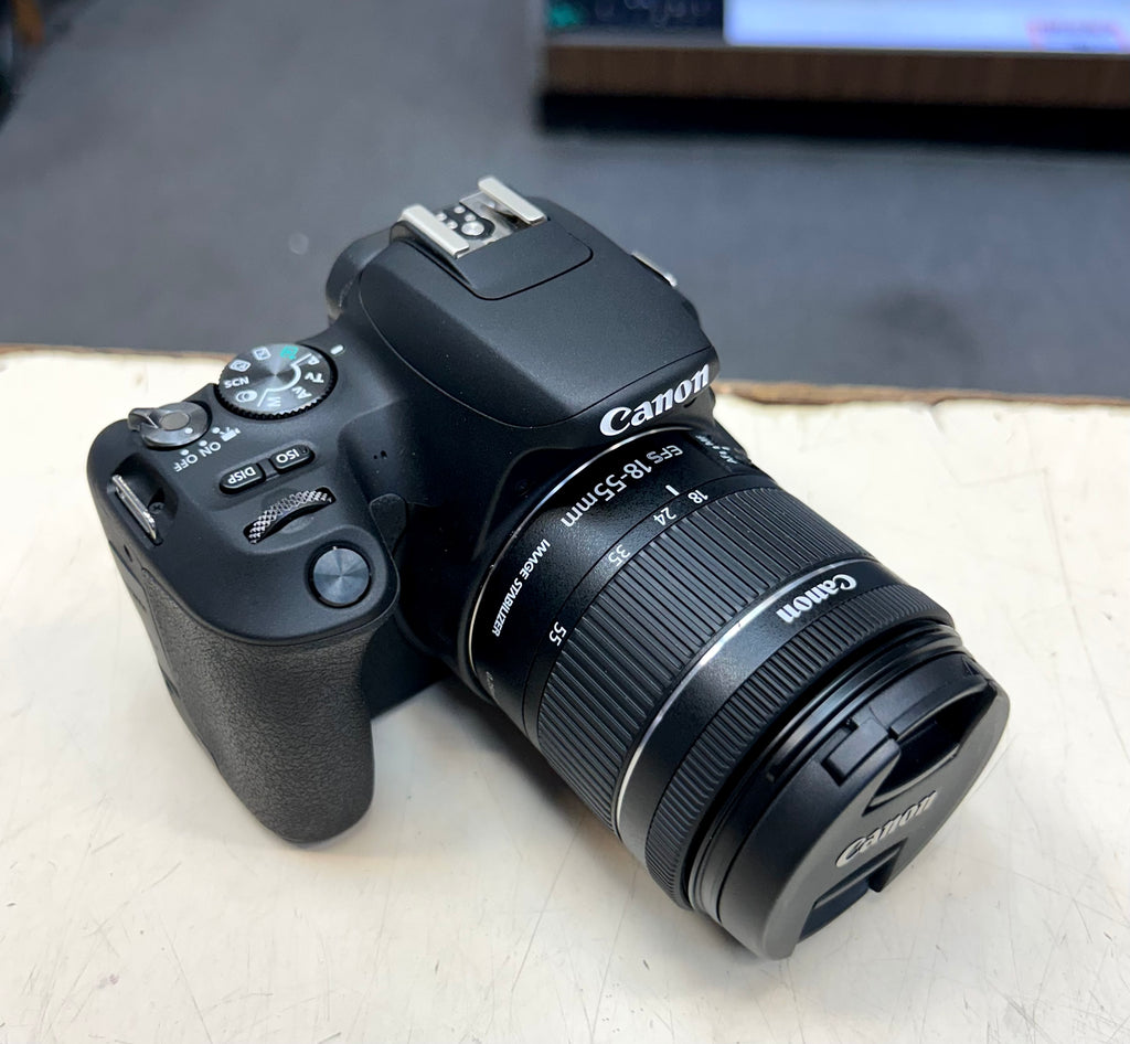 Canon camera on a light surface with a blurred background