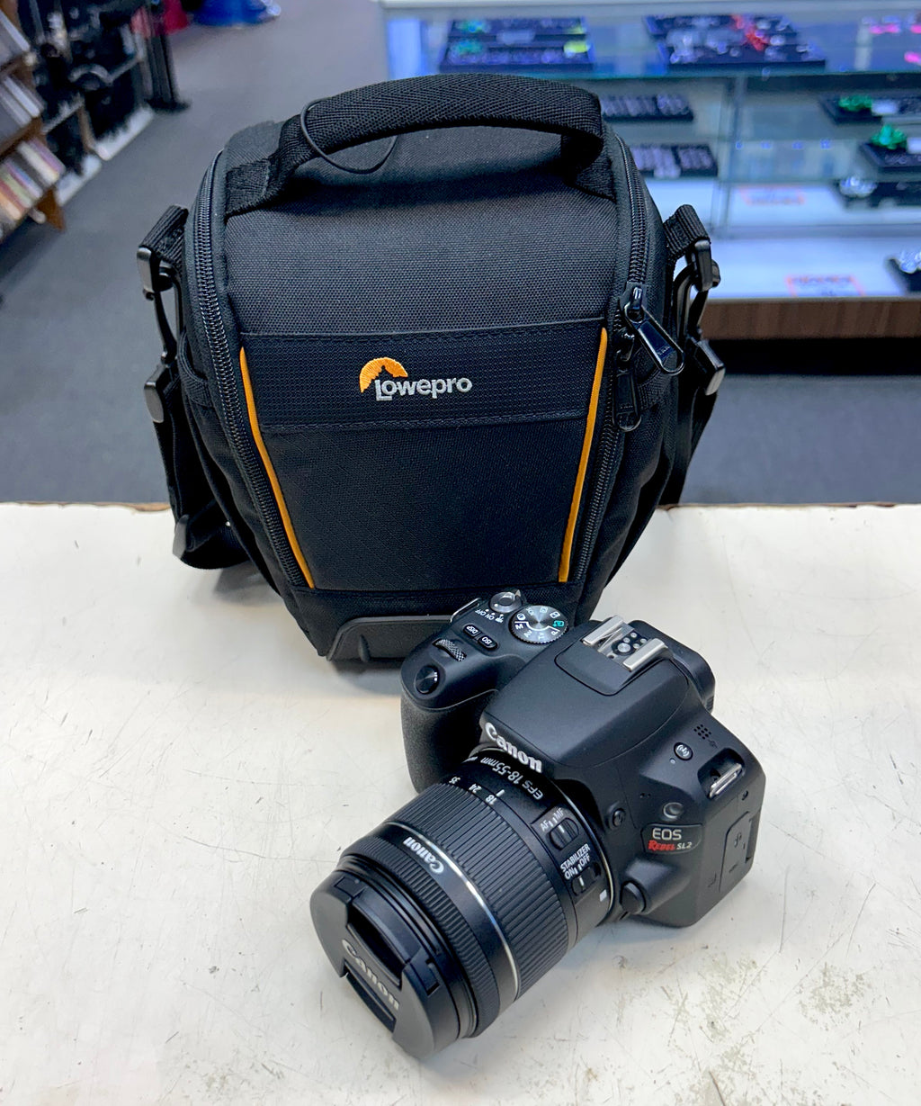 Cannon Camera and Lowepro camera bag on a table with a store background