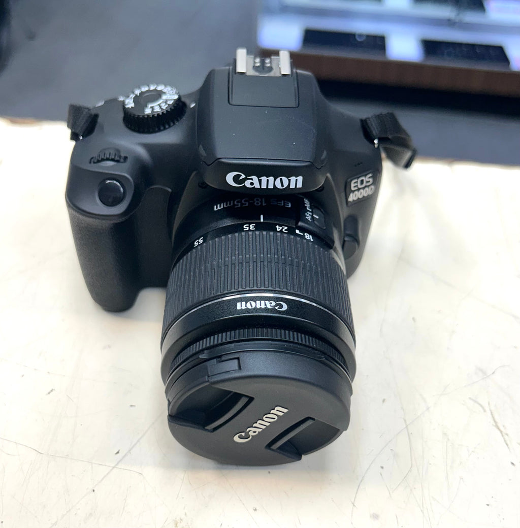 Canon EOS camera on a light surface with a blurred background