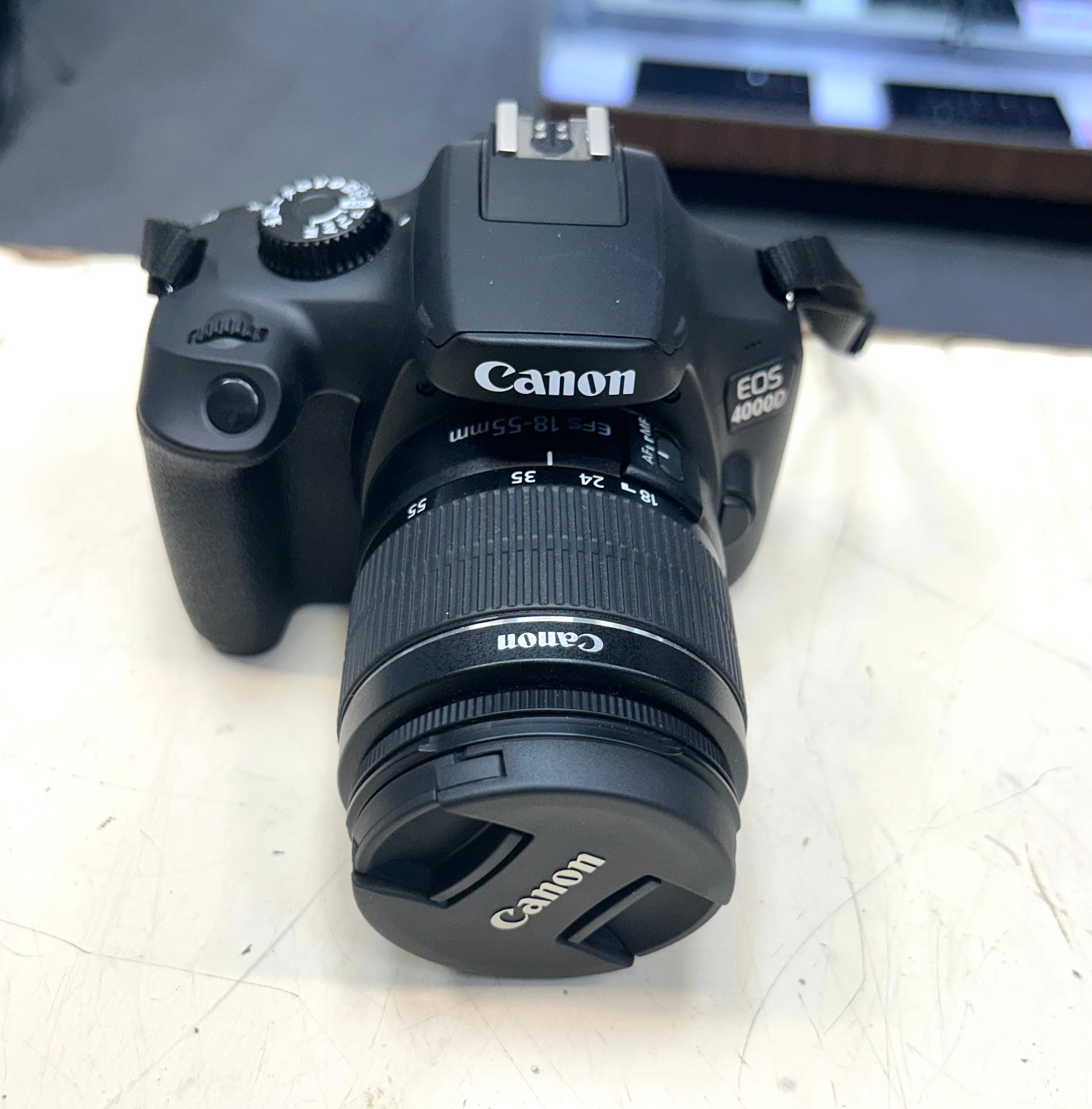 Canon EOS camera on a light surface with a blurred background