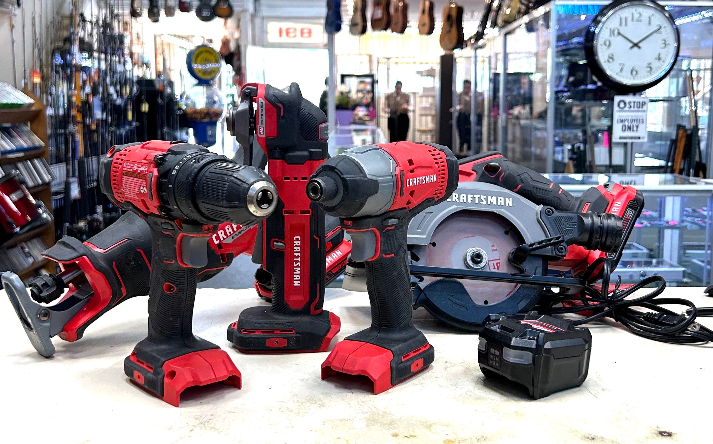 Set of cordless drills and a circular saw on display in a hardware store.