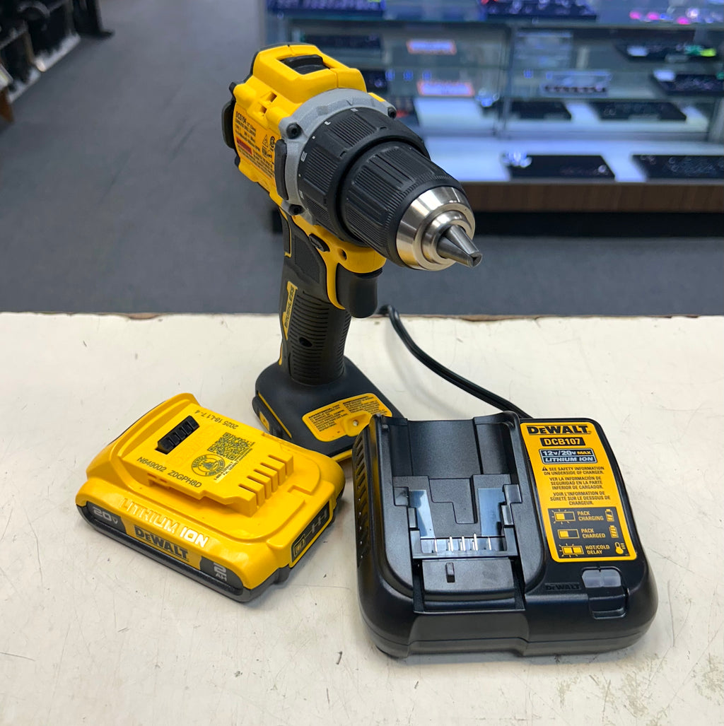 DeWalt cordless drill with battery and charger on a white surface