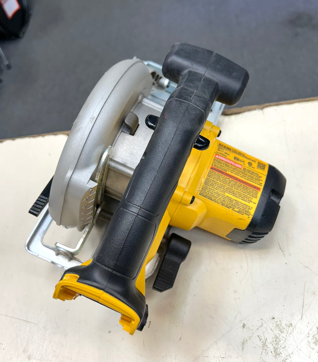 Circular saw with black and yellow handle on a white surface