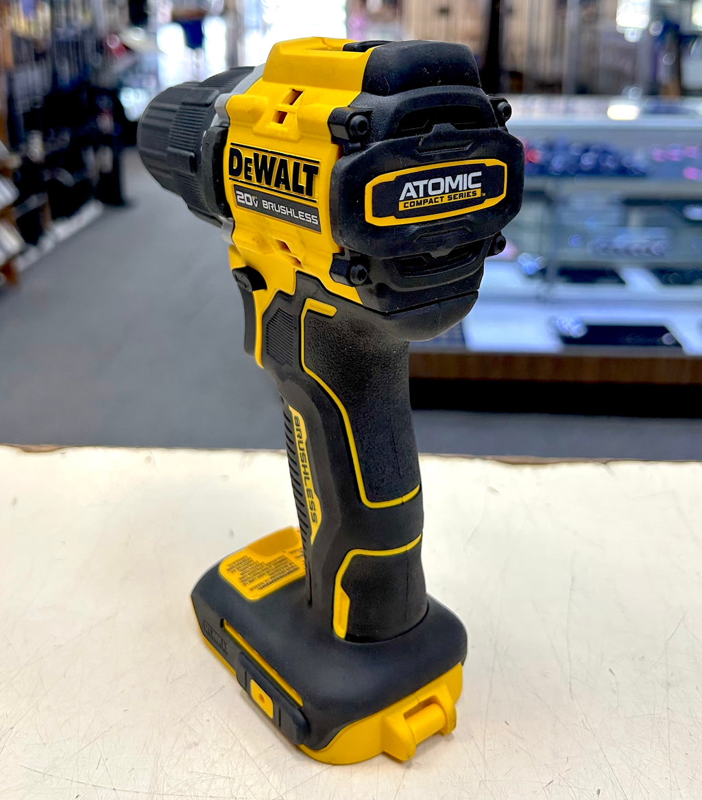 DeWalt cordless drill on a white surface with a blurred background