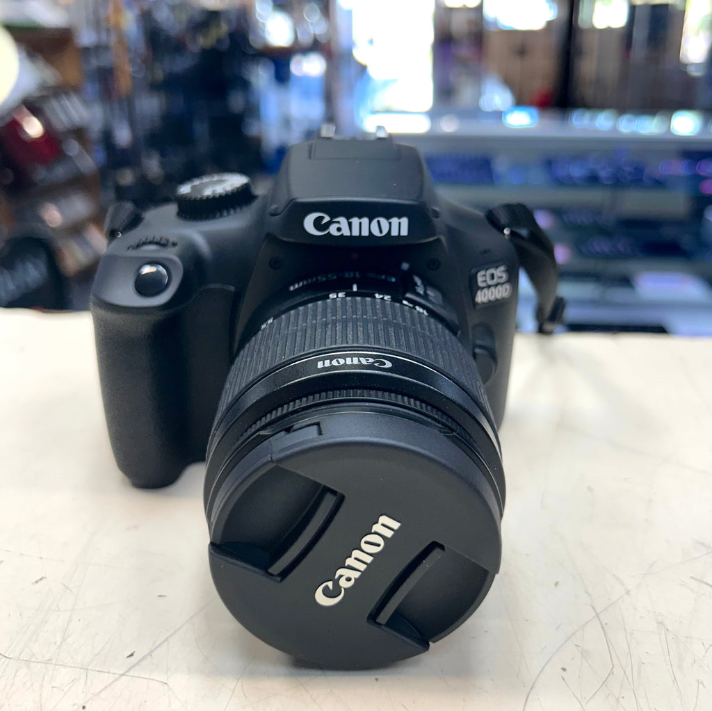 Canon EOS camera on a table with a blurred store background