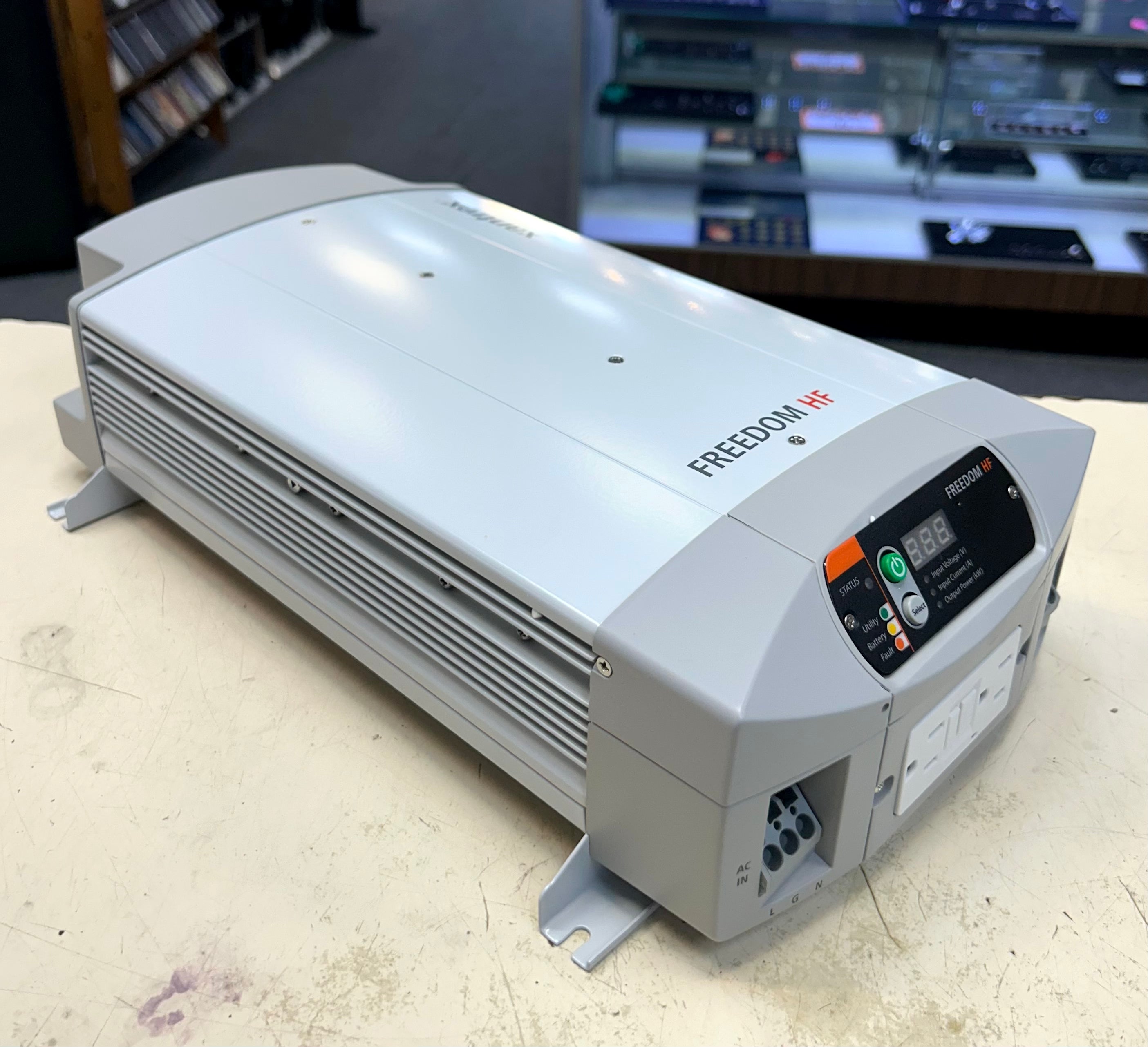 Power inverter labeled 'Freedom' on a table with a blurred background