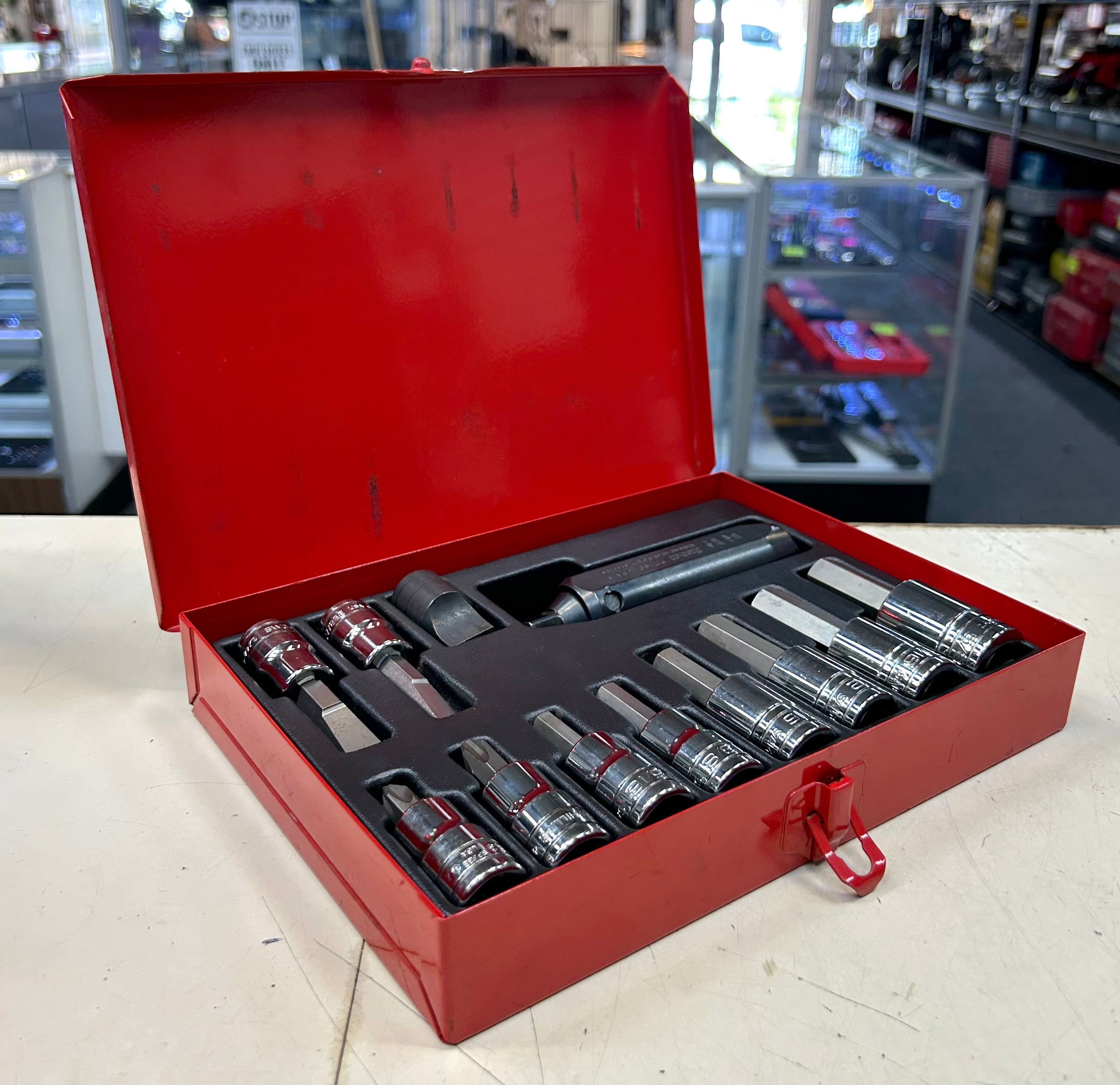 Set of sockets in a red tool box on a workbench