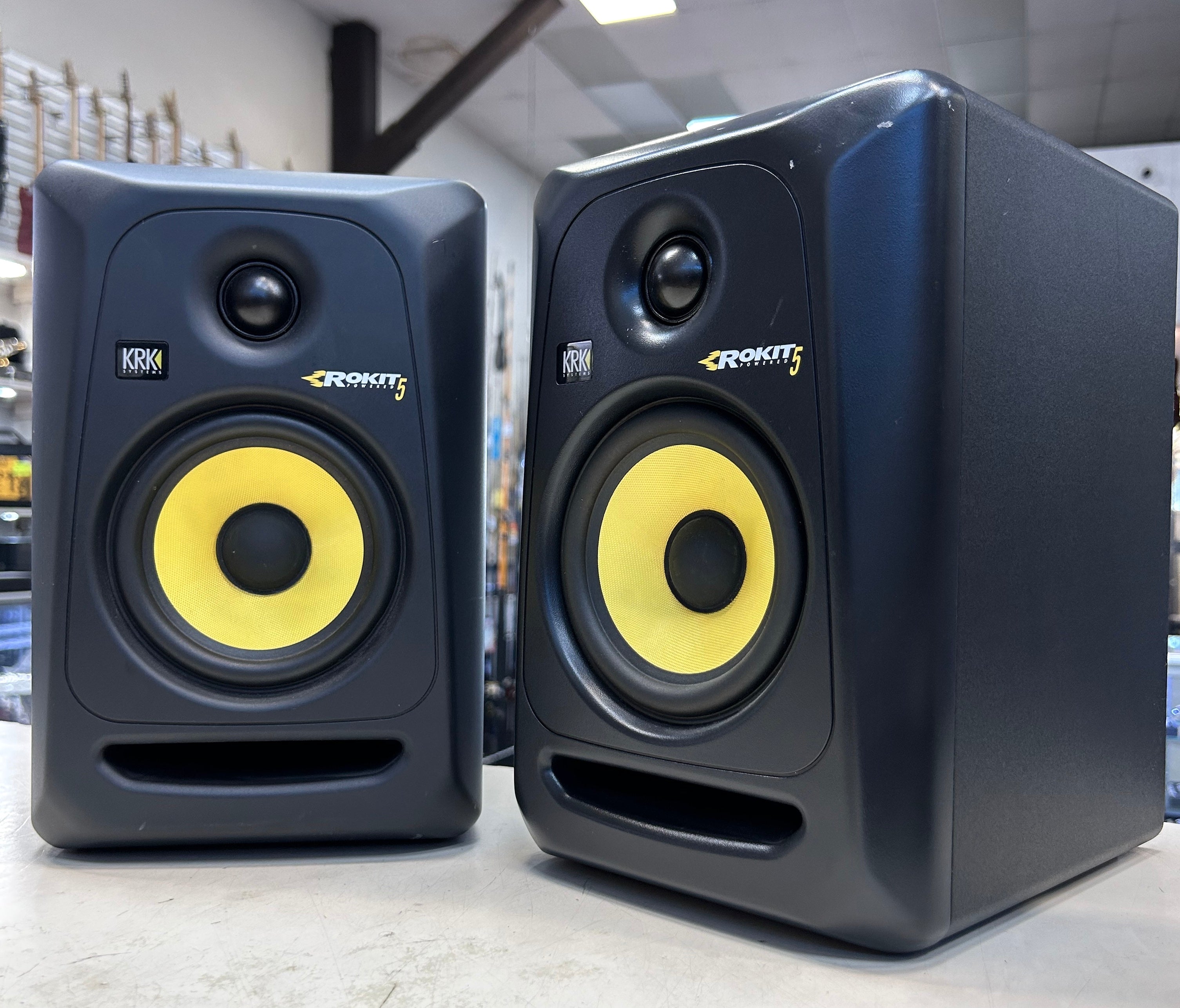 Pair of KRK ROKIT 5 studio monitors in a store setting