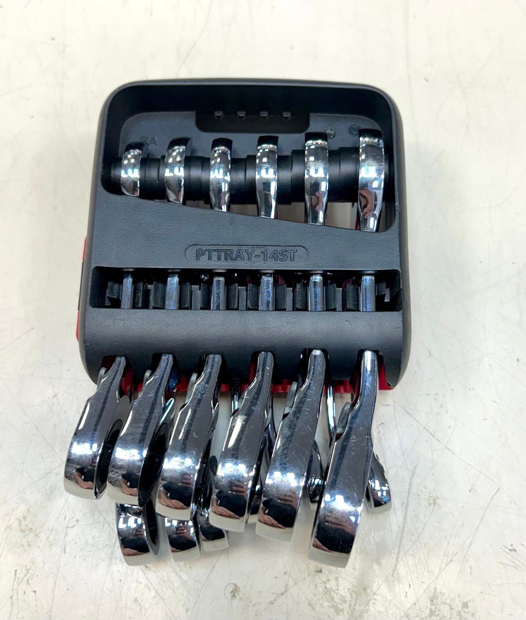 Set of wrenches in a black and red tool tray on a light gray background