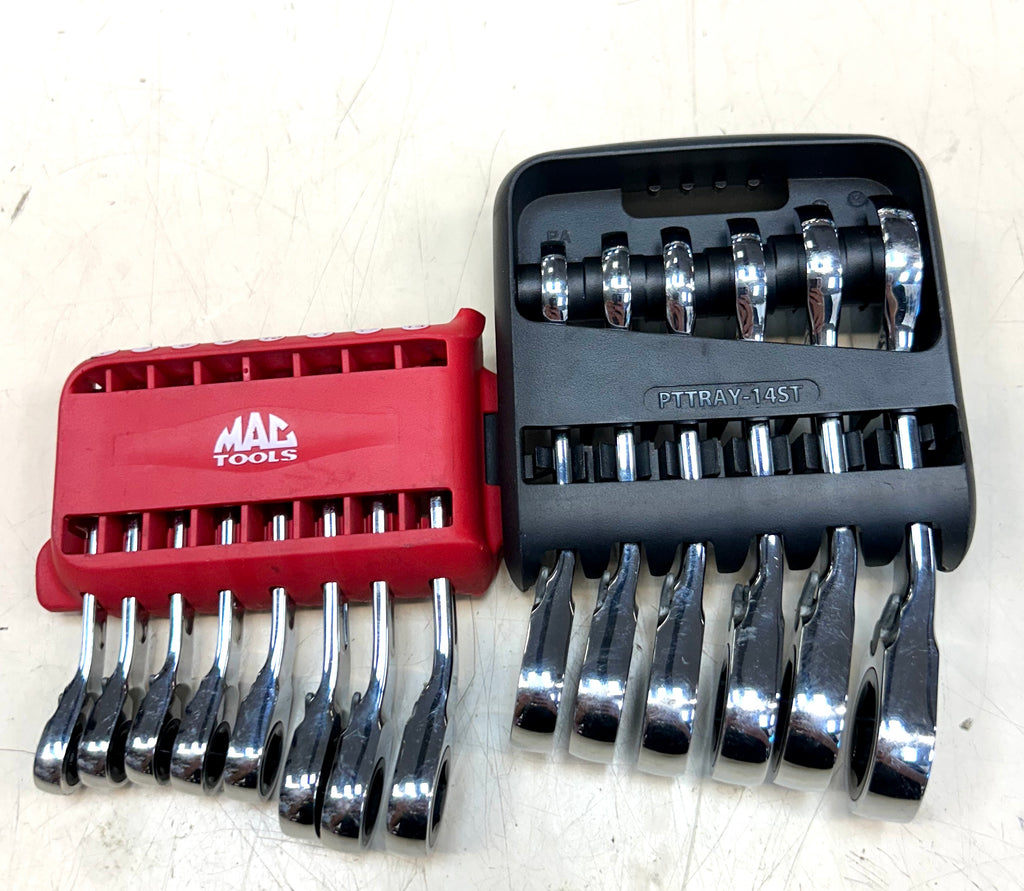 Set of socket wrenches in red and black tool cases on a white background
