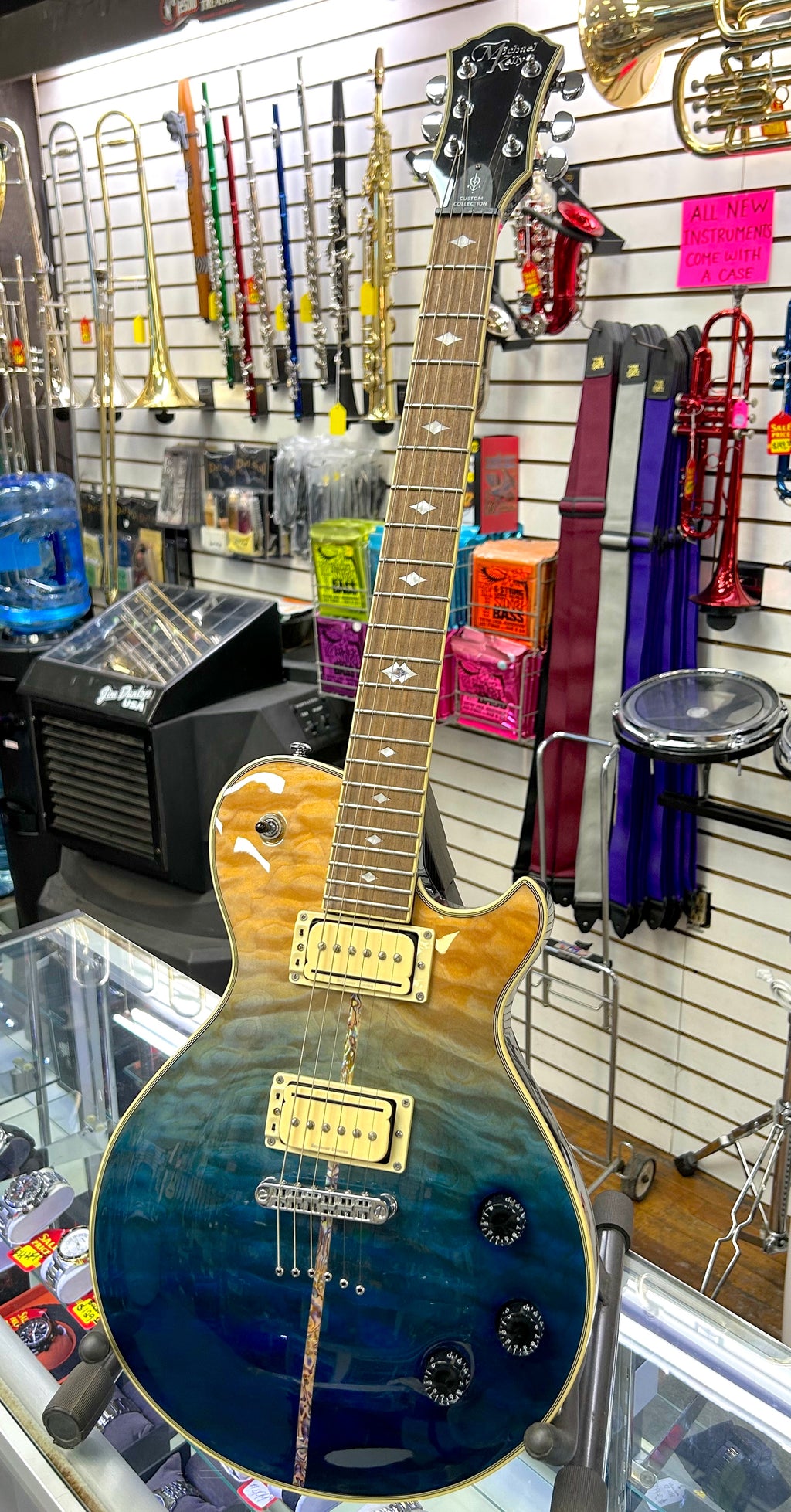 Electric guitar on display in a music store with various instruments in the background