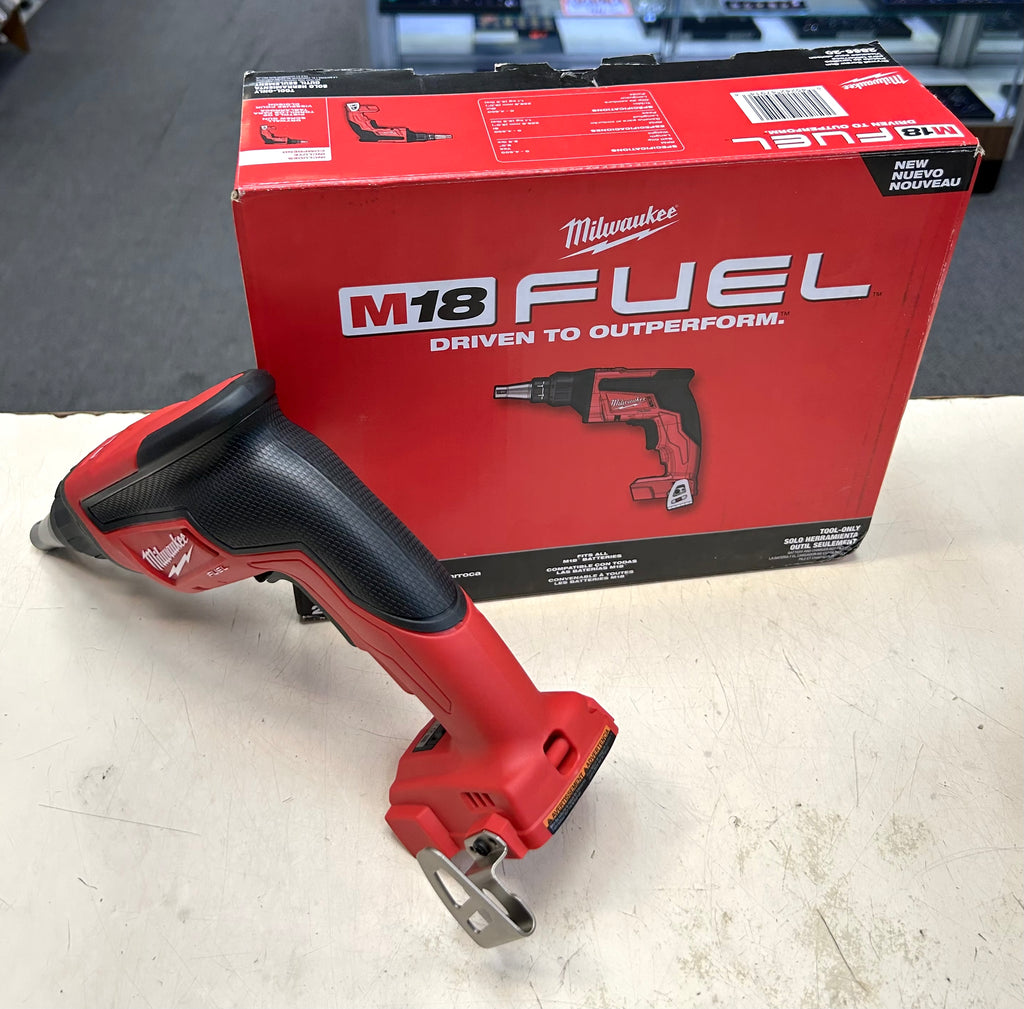 Red Milwaukee tool on a white surface with a red Milwaukee box in the background.