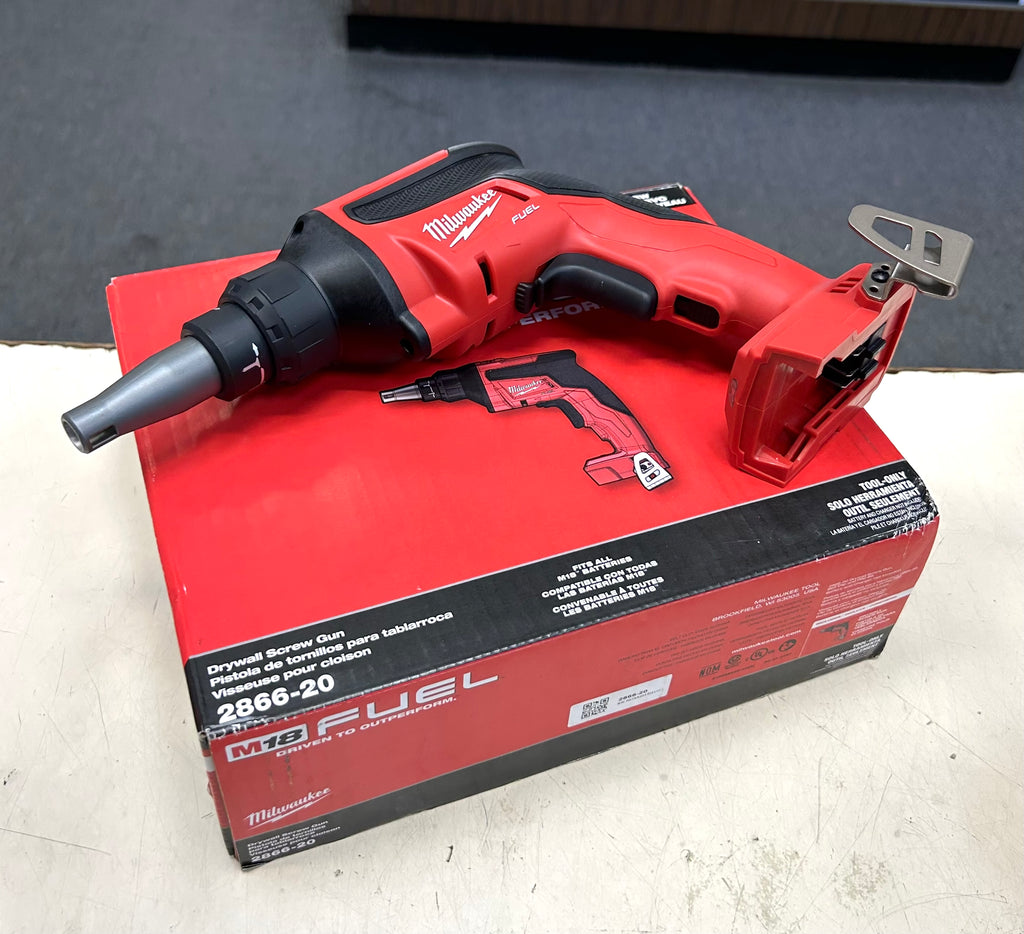 Red Milwaukee power tool on a white surface with a gray background