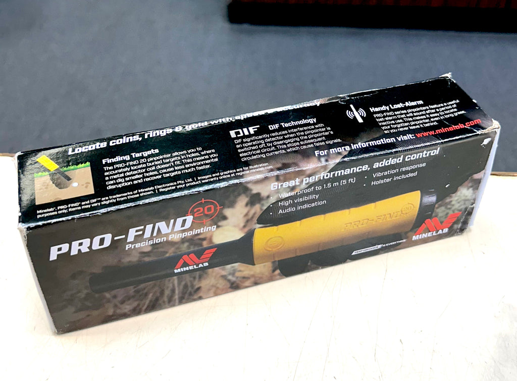 Box of a handheld metal detector with branding and product details on a gray surface
