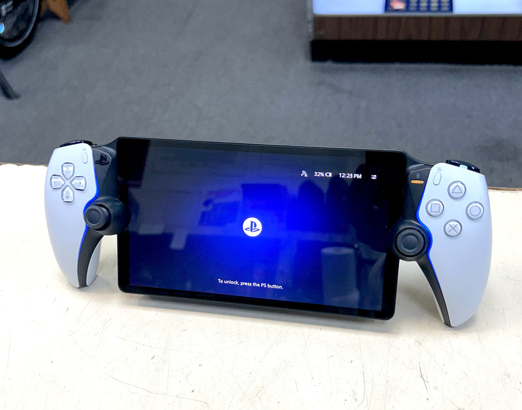 PlayStation gaming console with controller on a white surface