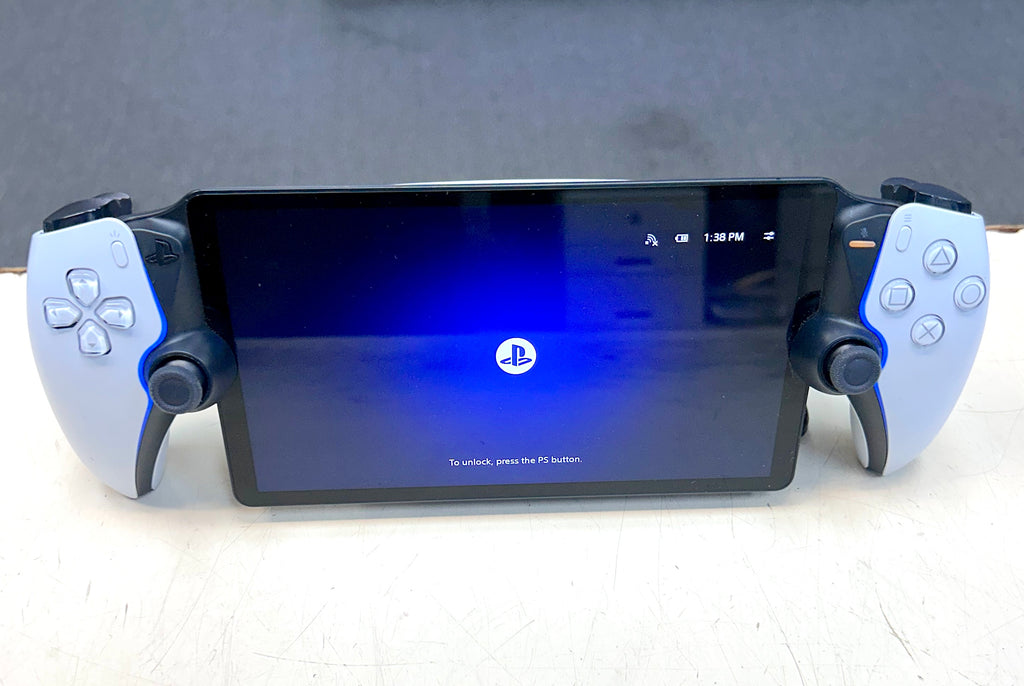PlayStation gaming console with controller on a light surface