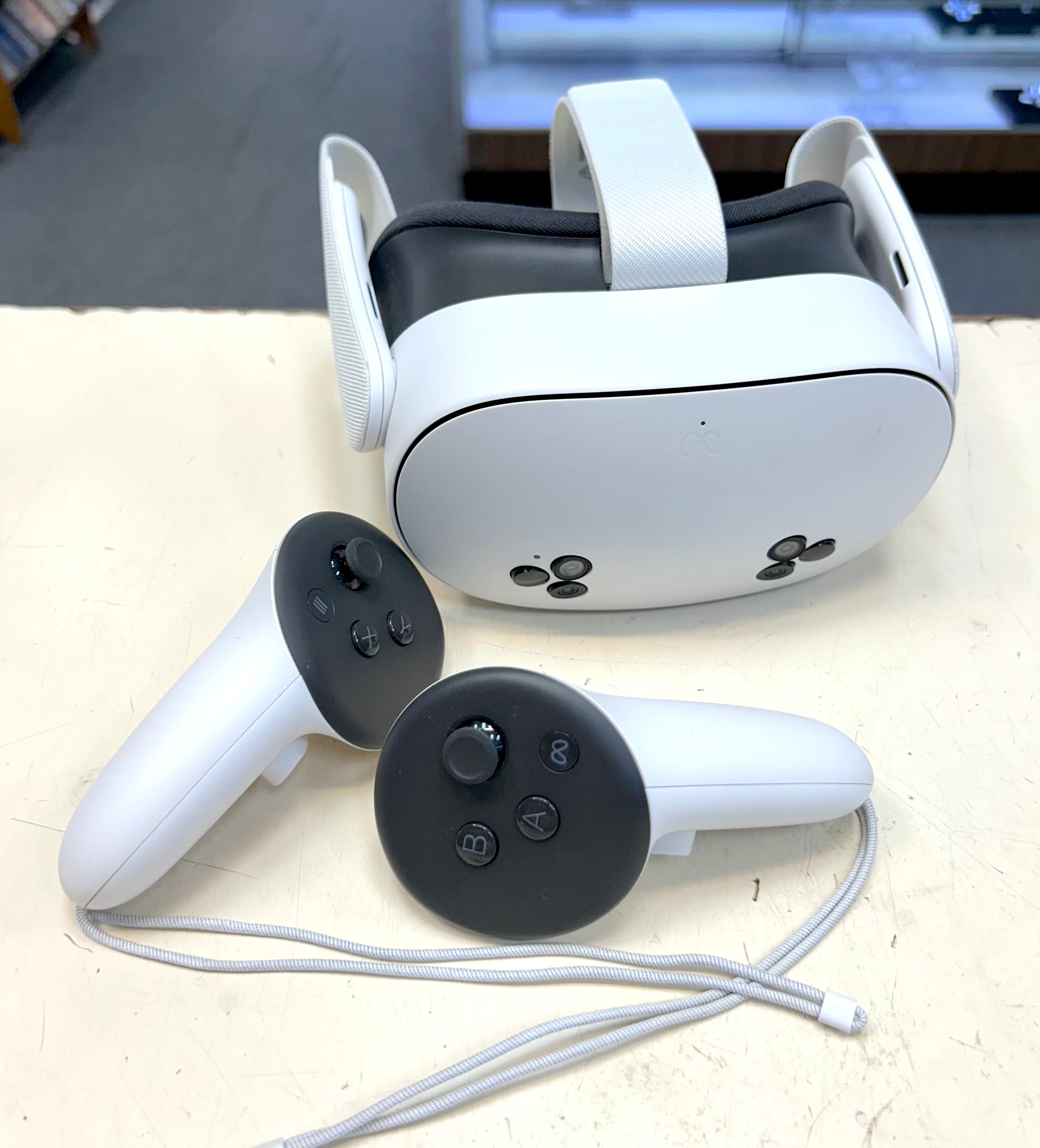 Meta Quest 3s VR headset and controllers on a light surface