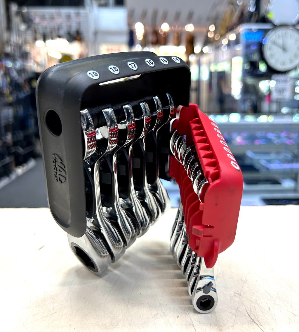 Set of wrenches in a holder with a blurred store background