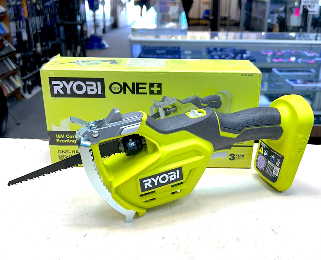 Ryobi power tool on a white surface with packaging in the background