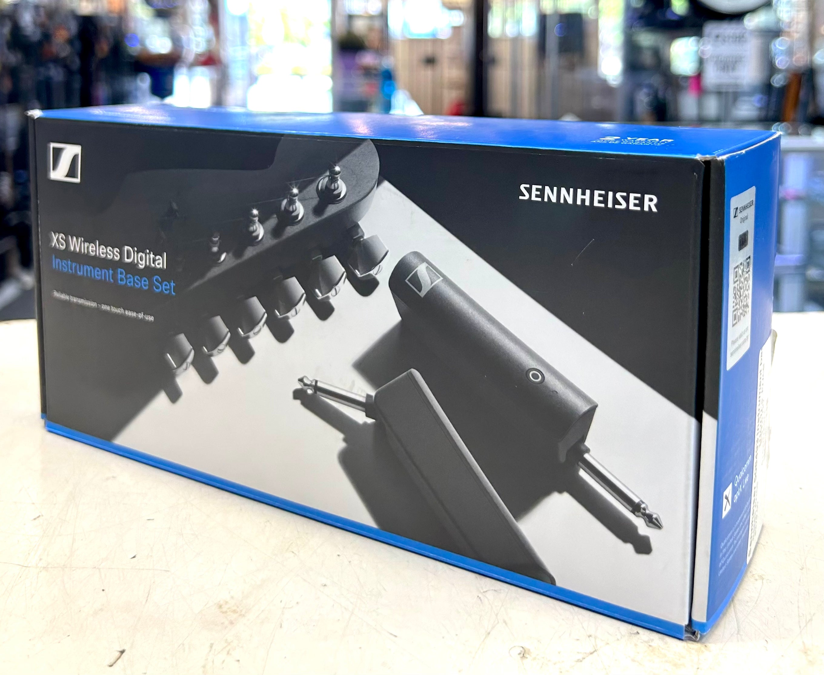 Sennheiser XS Wireless Digital Instrument Base Set packaging on a light surface with blurred background