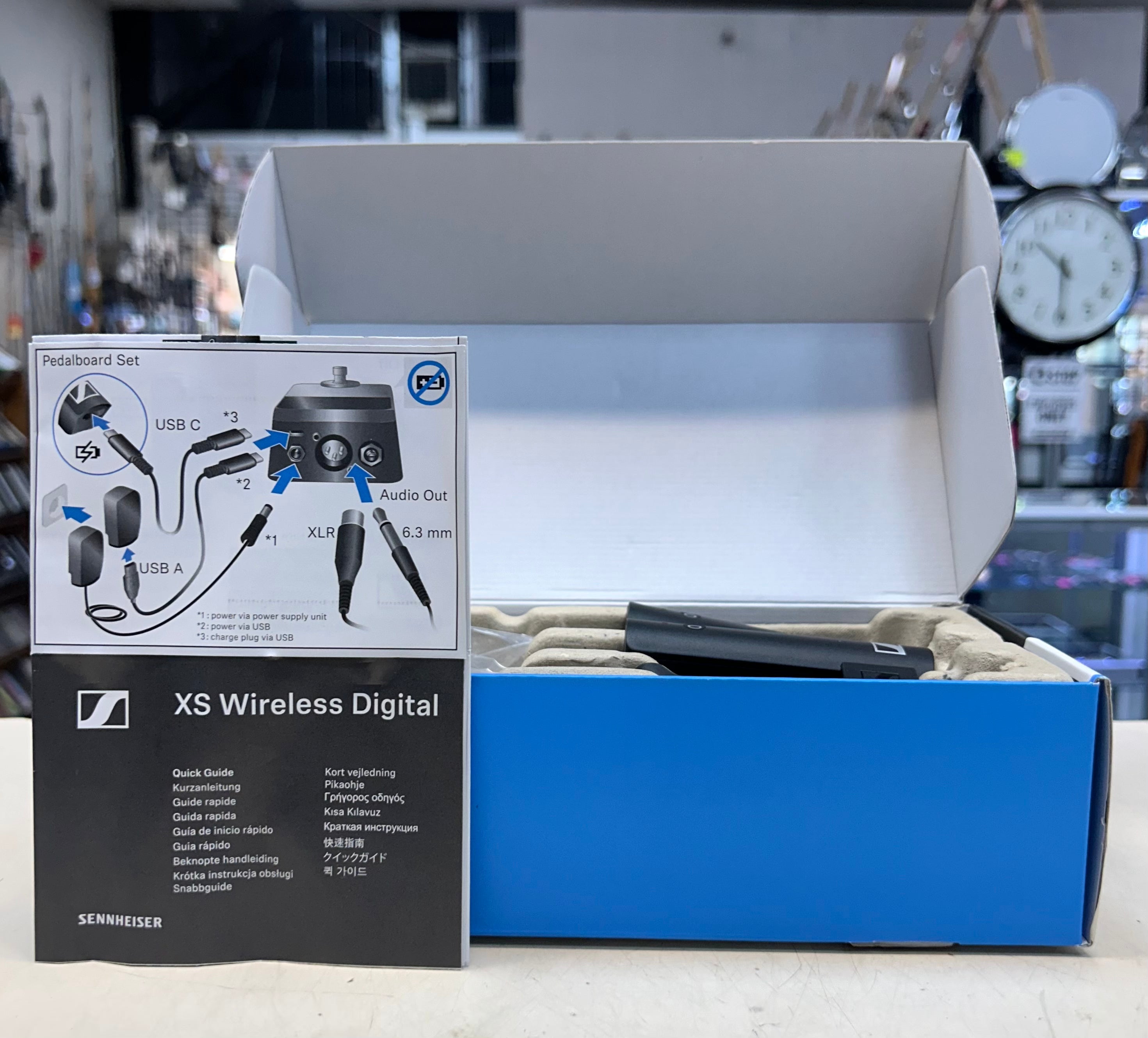 Sennheiser XS Wireless Digital microphone set packaging with accessories on a blurred background
