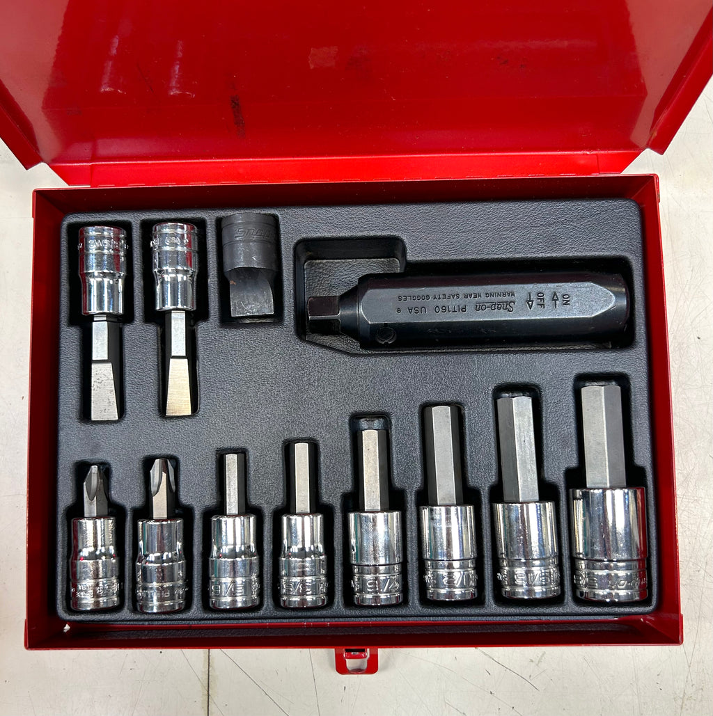 Set of sockets and tools in a red tool box on a white background