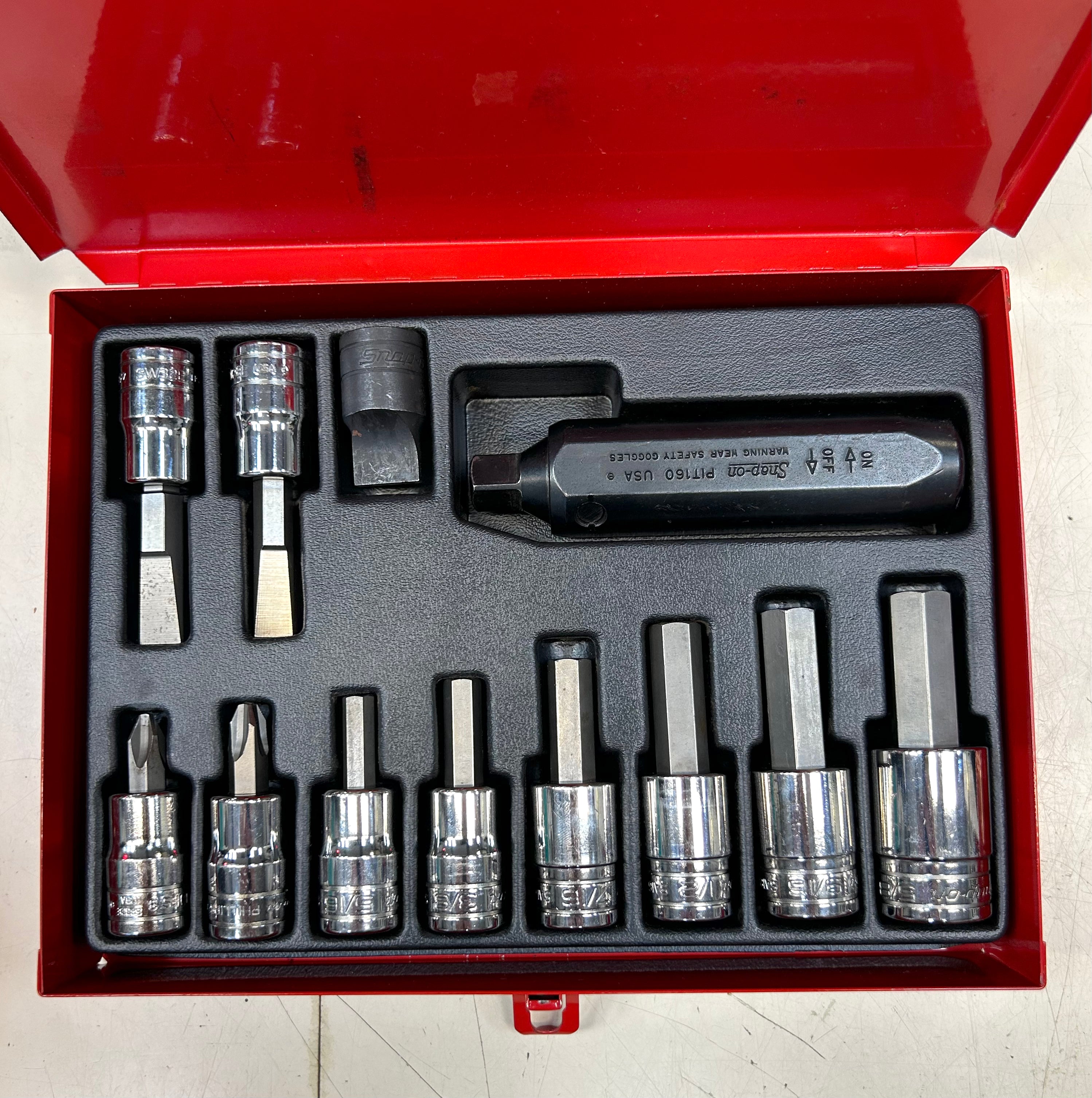 Set of sockets and tools in a red tool box on a white background