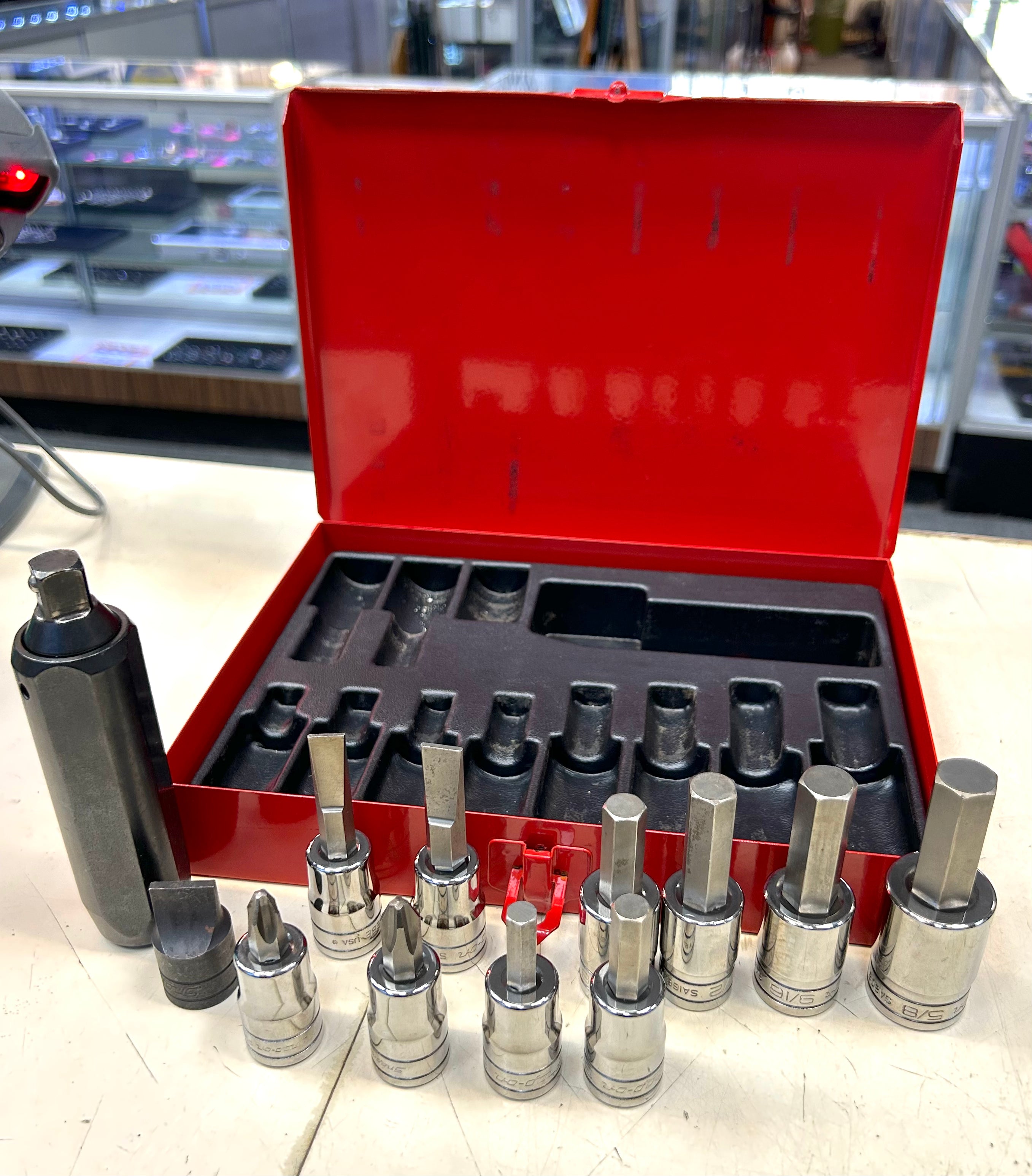 Set of socket tools with a red toolbox on a counter