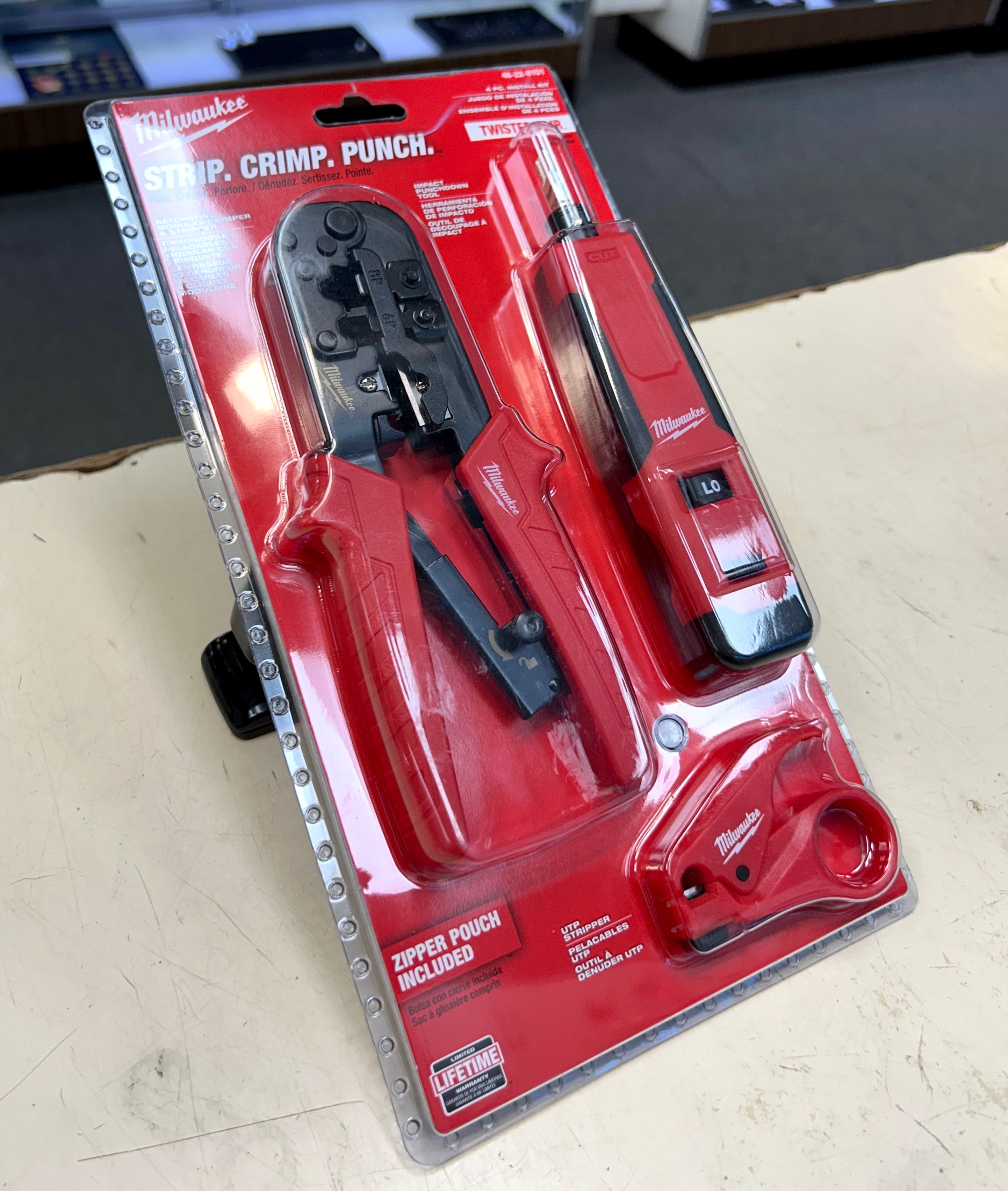 Milwaukee crimping tool set on a red packaging with visible branding.