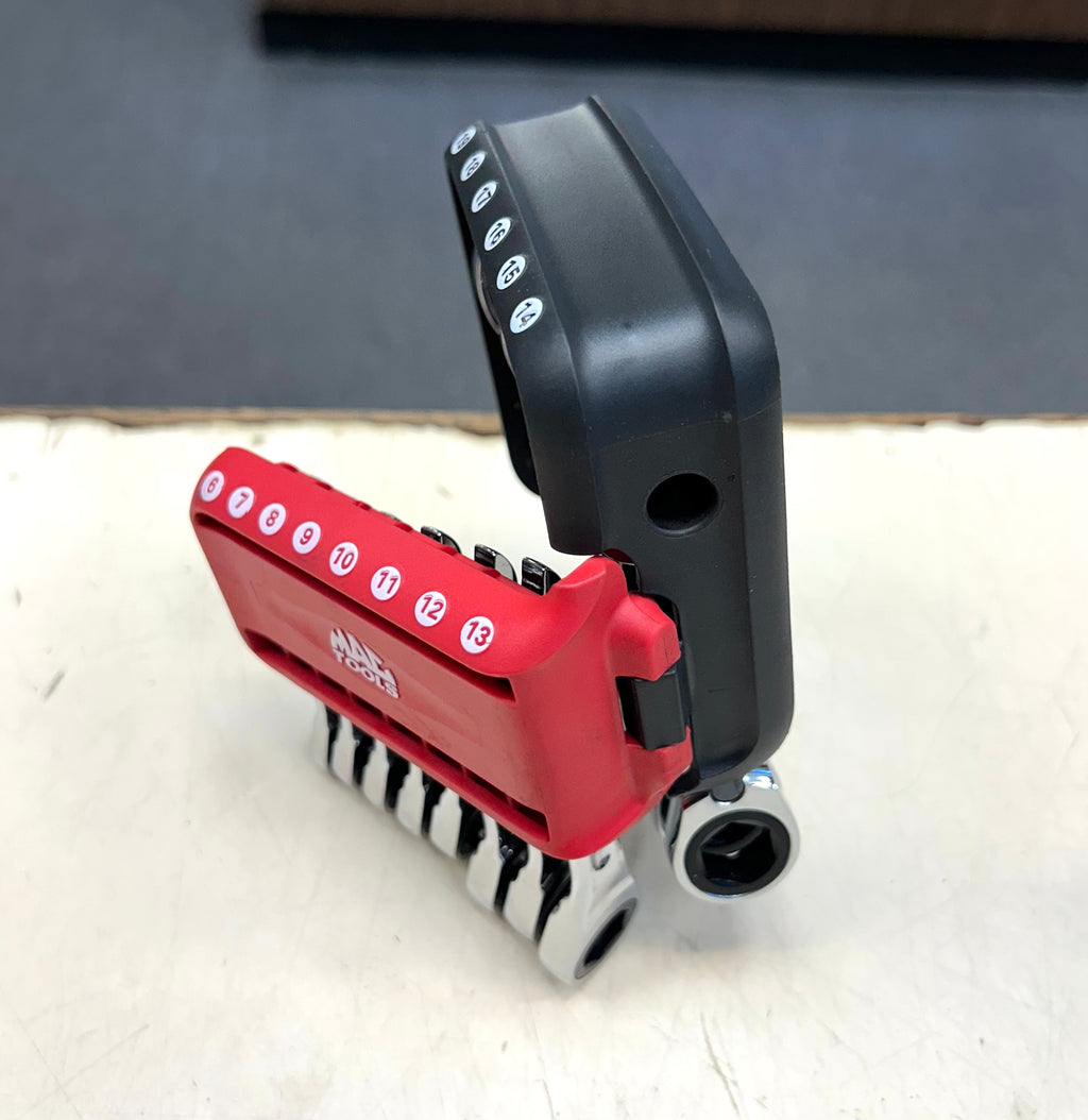 Multitool with red and black design on a white surface